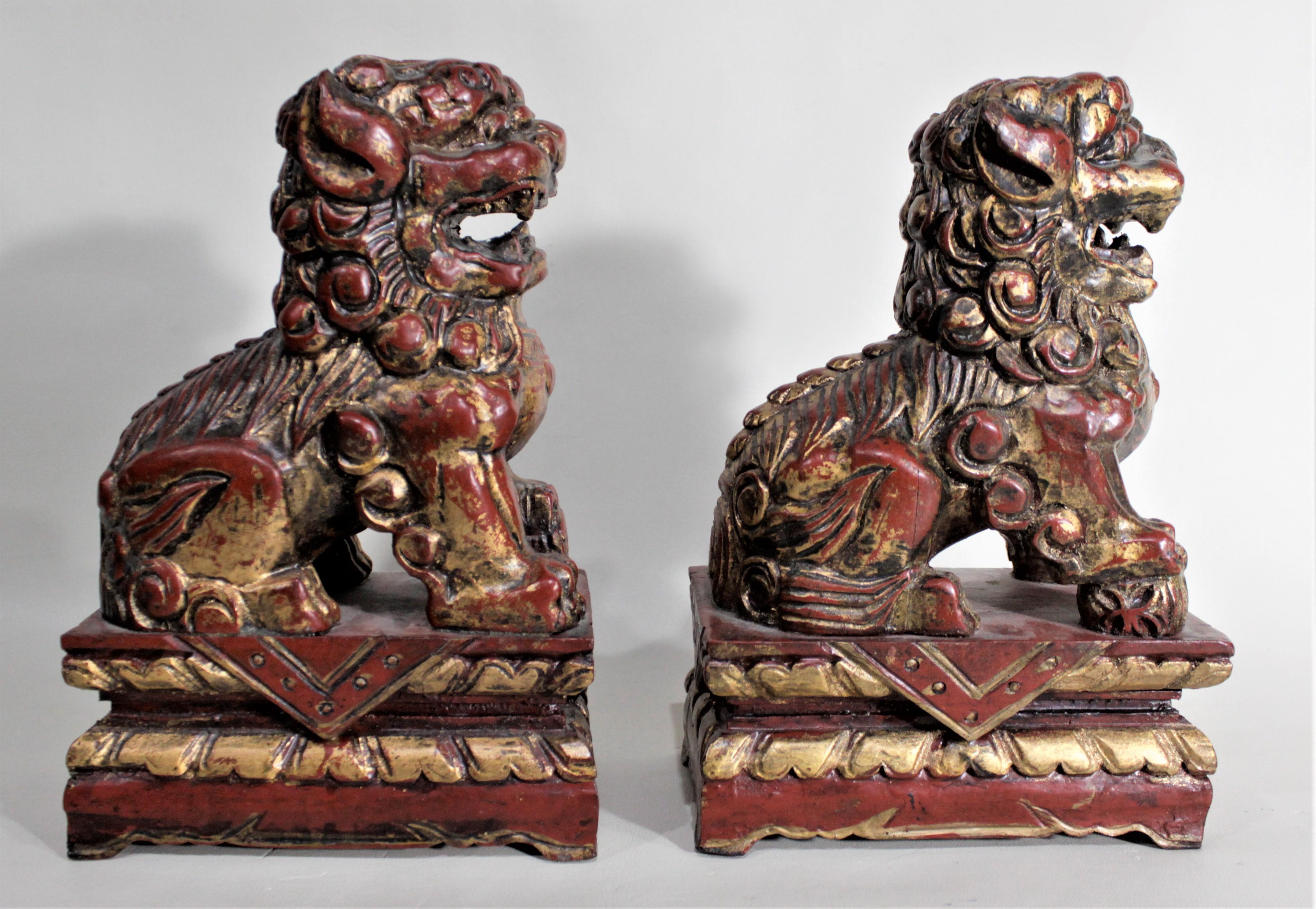 Chinese Export Pair of Carved Wood and Gilt Finished Chinese Foo Dog Figurines or Sculptures For Sale
