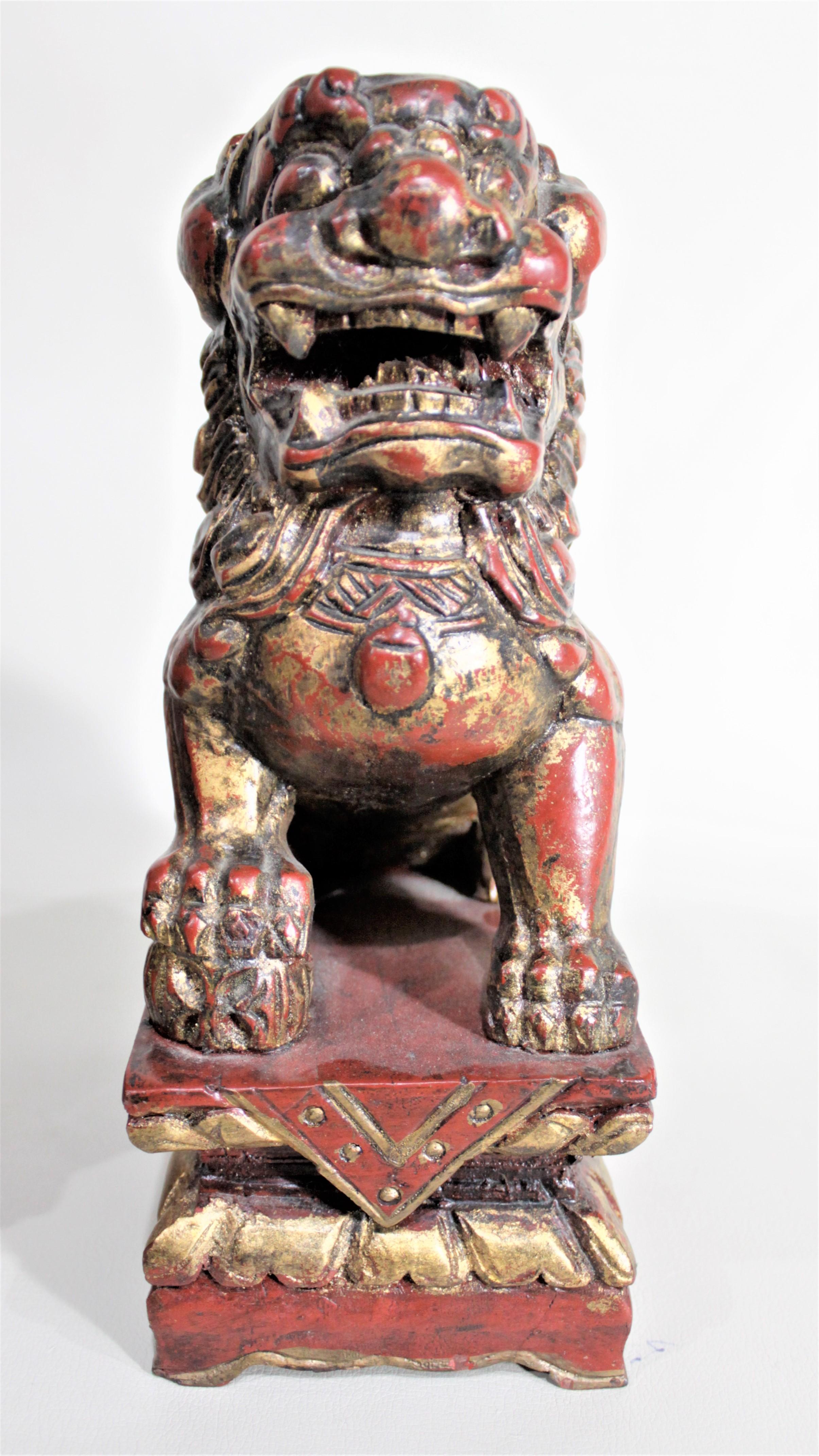 20th Century Pair of Carved Wood and Gilt Finished Chinese Foo Dog Figurines or Sculptures For Sale