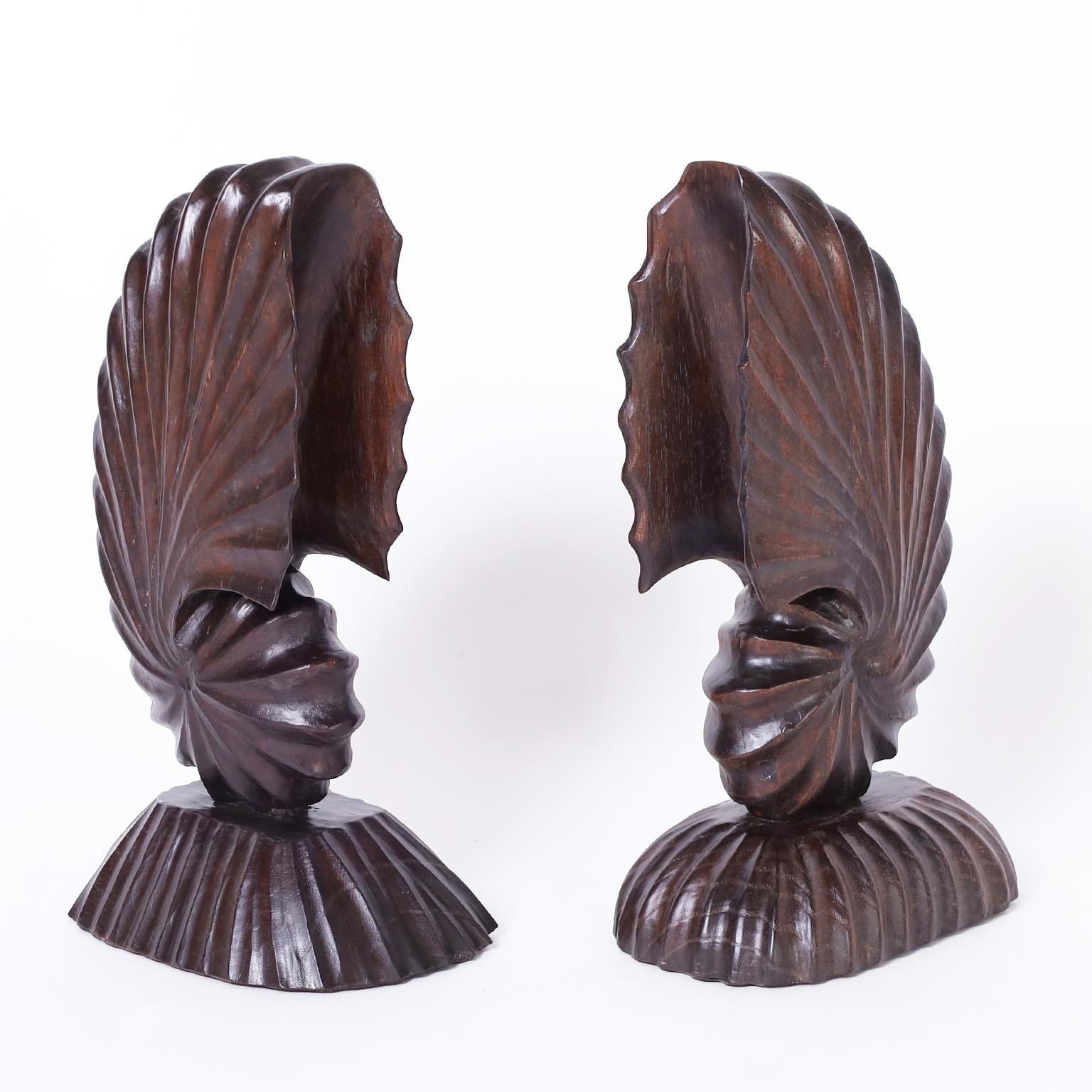 Mid-century nautilus sculptures or objects of art carved from mahogany in a stylized form with a dark lush finish.
