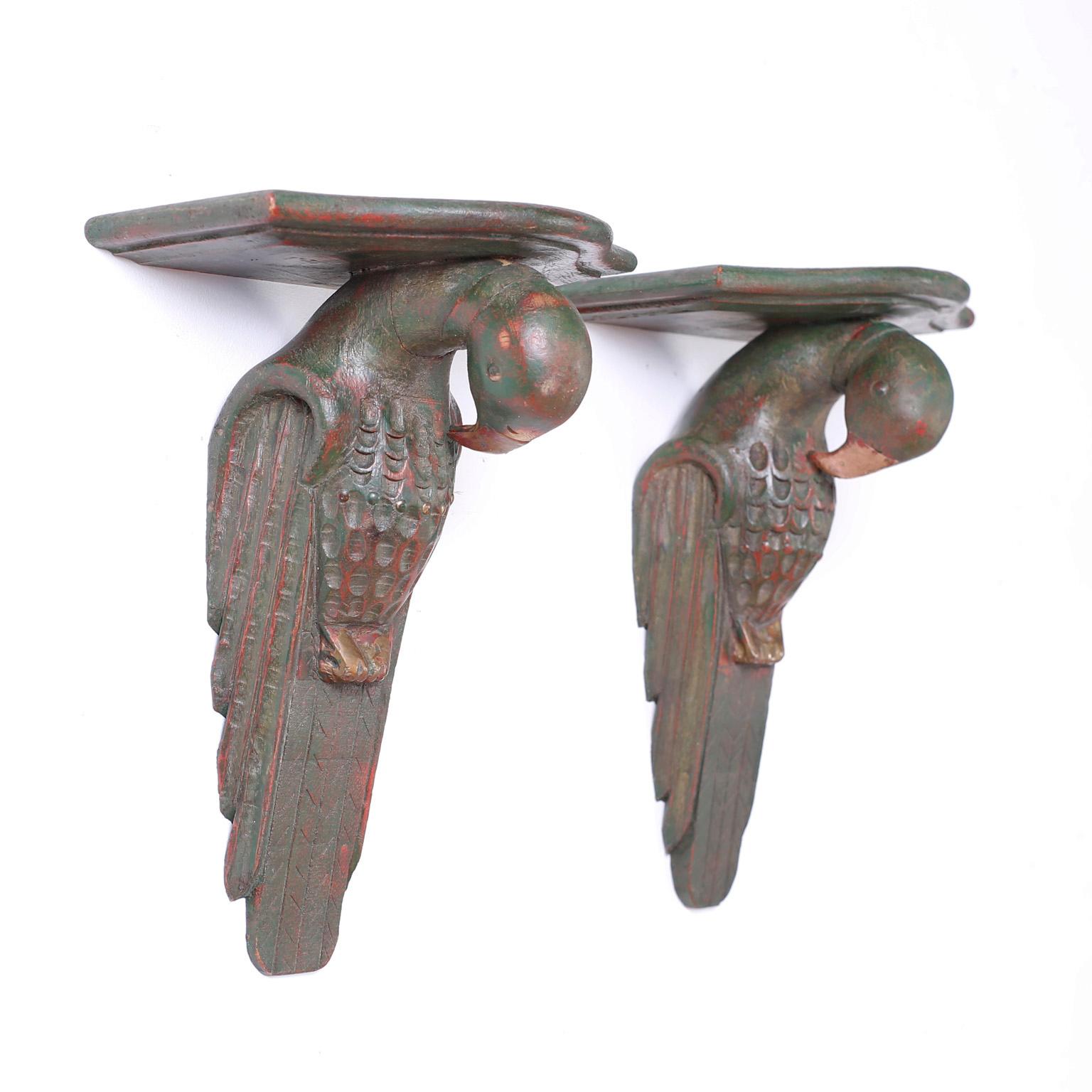 Pair of hand carved wood parrot or bird wall brackets with inspired bronze like finish and bold stylized form.