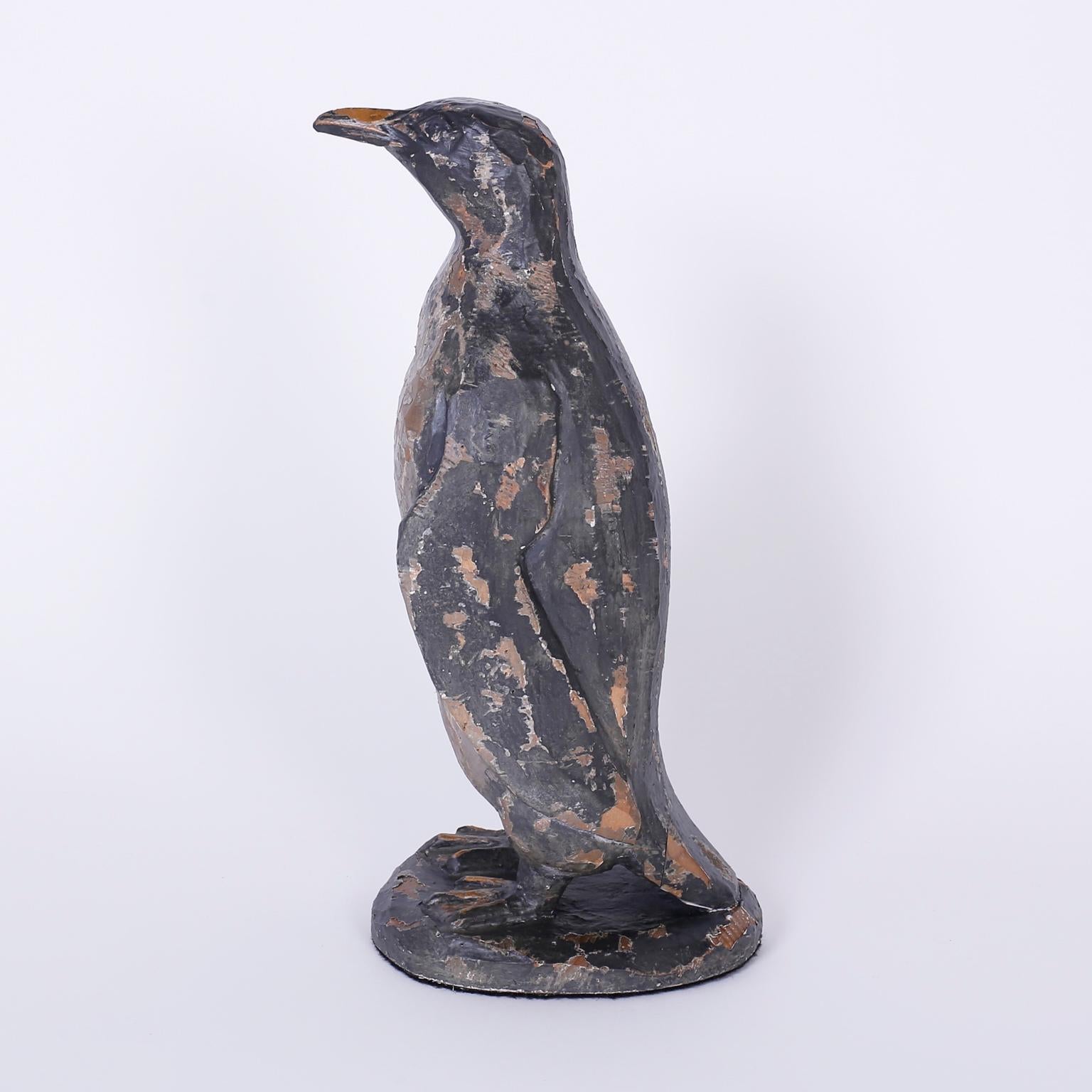 Pair of carved wood penguins or birds with a weathered, time warn patina and a folky, lovable presence.
    