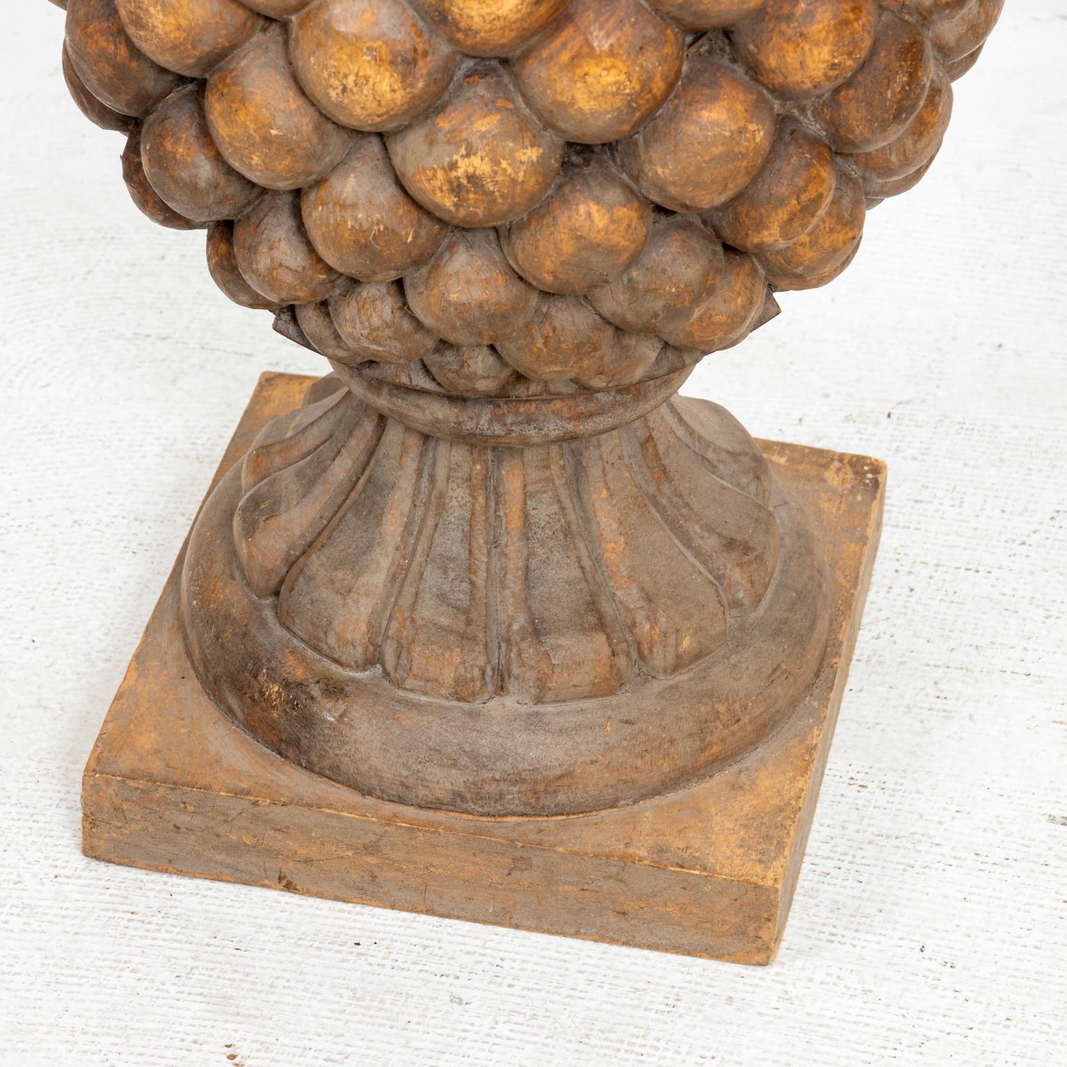 Pair of carved wood pineapple lamps with a graduating design on square base. Please note of wear consistent with age including fair condition and structural damage with significant cracks in wood. Shade not included.