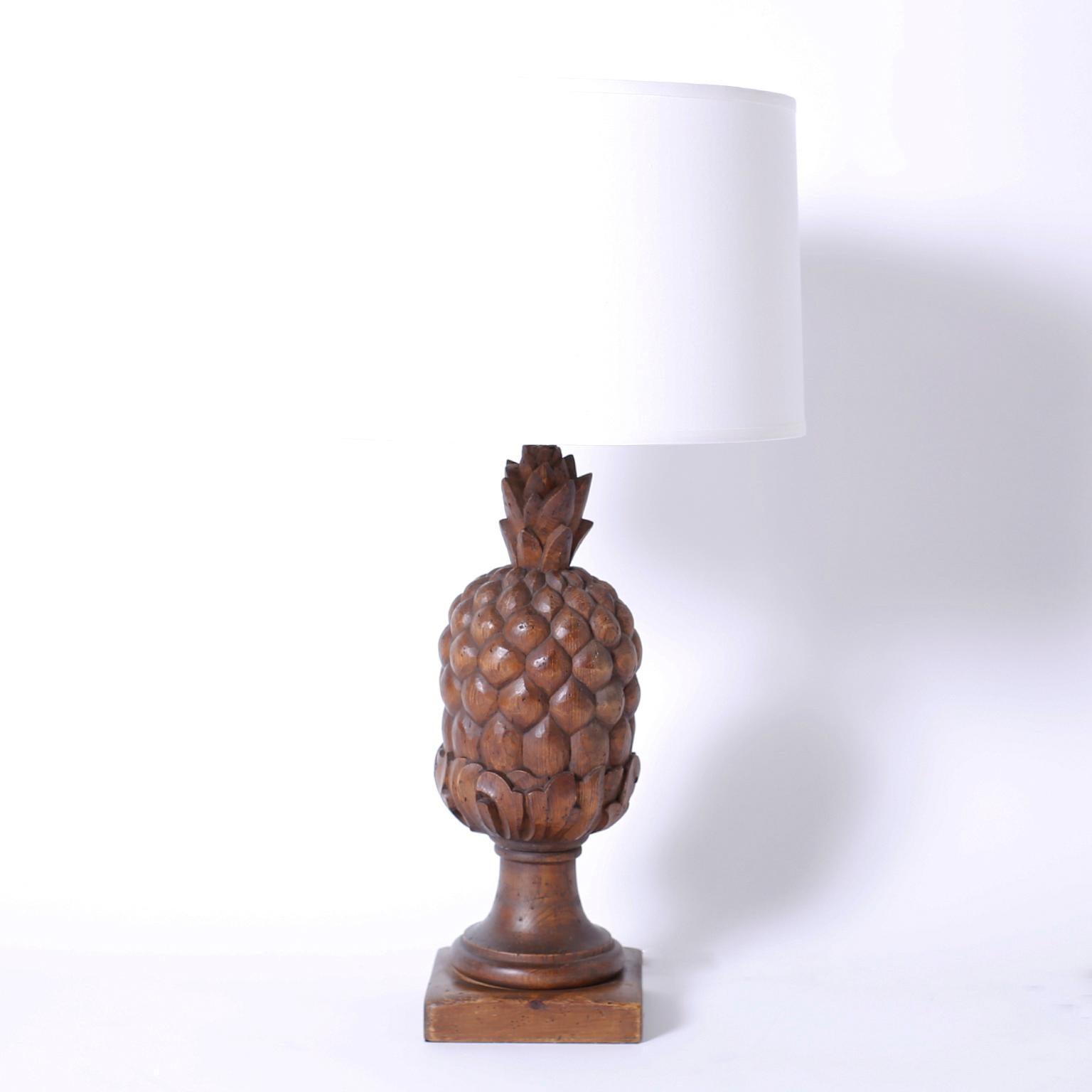 Pair of midcentury wood pineapple table lamps carved in a bold stylized technique and set on Classic wood plinths.
