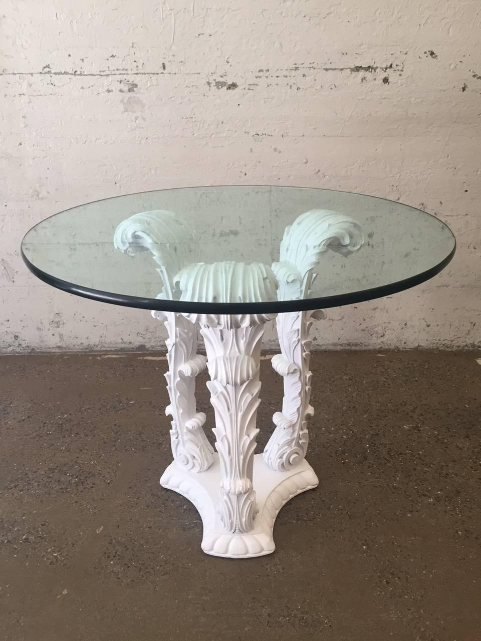 Pair of carved wood tables in the style of Serge Roche. Tables are white lacquered on a solid, carved wood base.