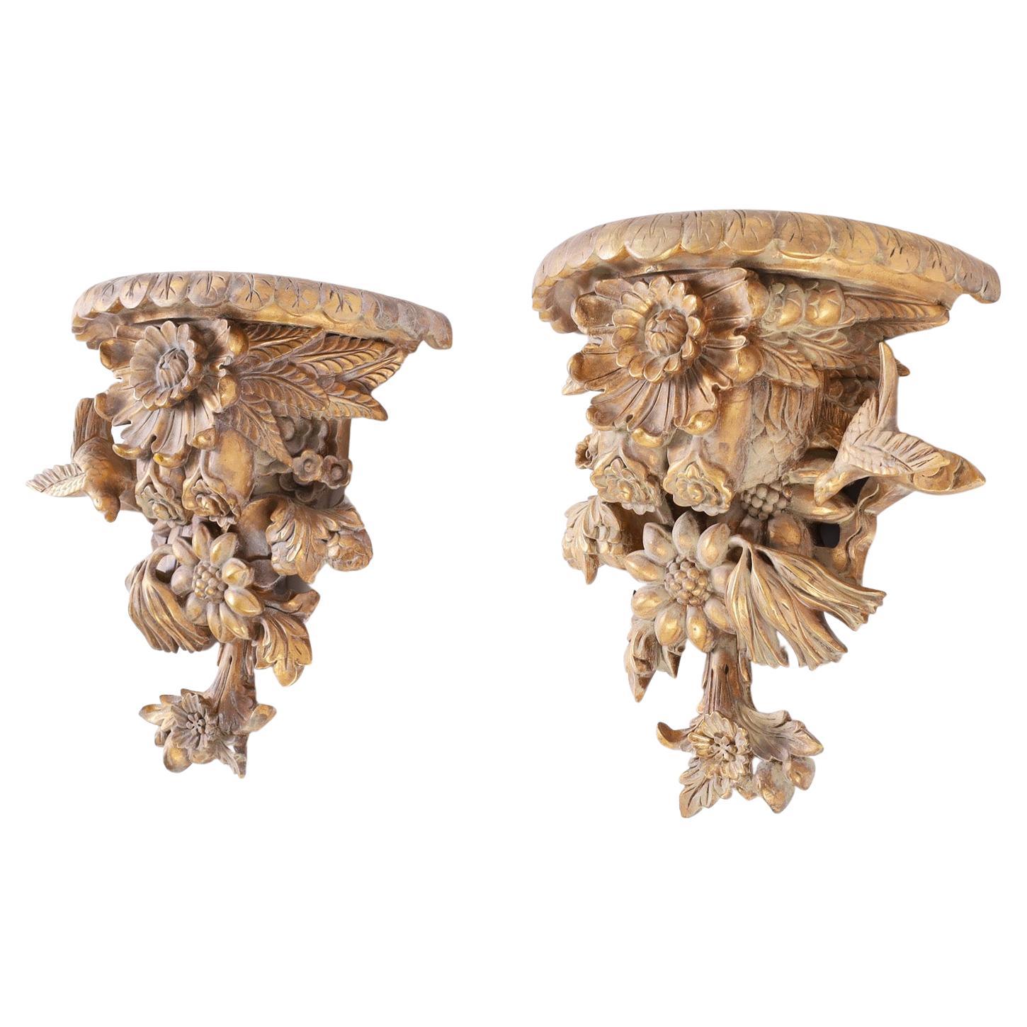 Pair of Rococo style Italian wall brackets crafted in wood, expertly carved with a flower and bird motif having a white wash over gilt old world style finish.