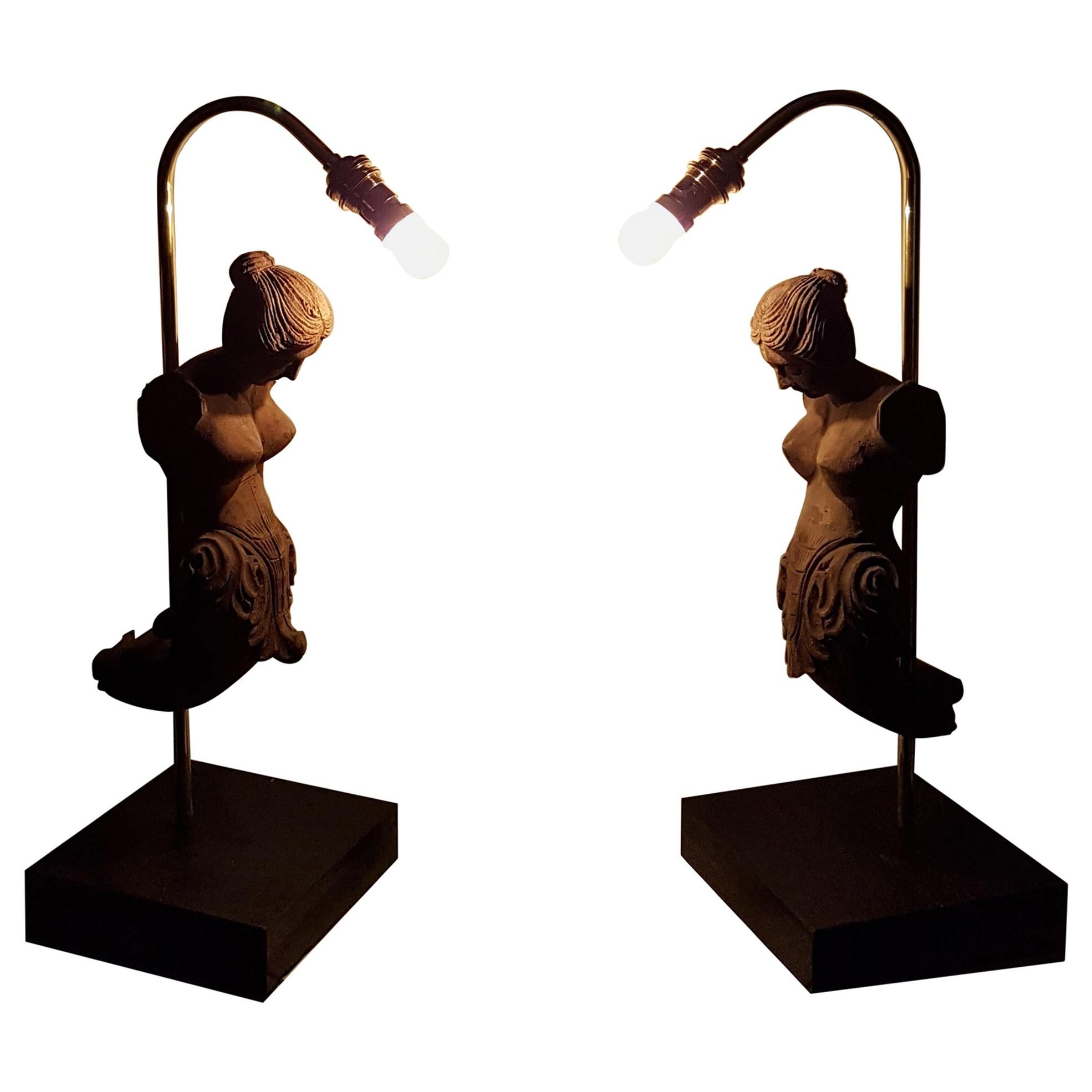 A nice decorative pair of table lamps constructed using old mid-20th century carved elements mold forms that depict female figures. There are minor losses to the carved figures that adds to their rustic appeal. These molds were used to take casting