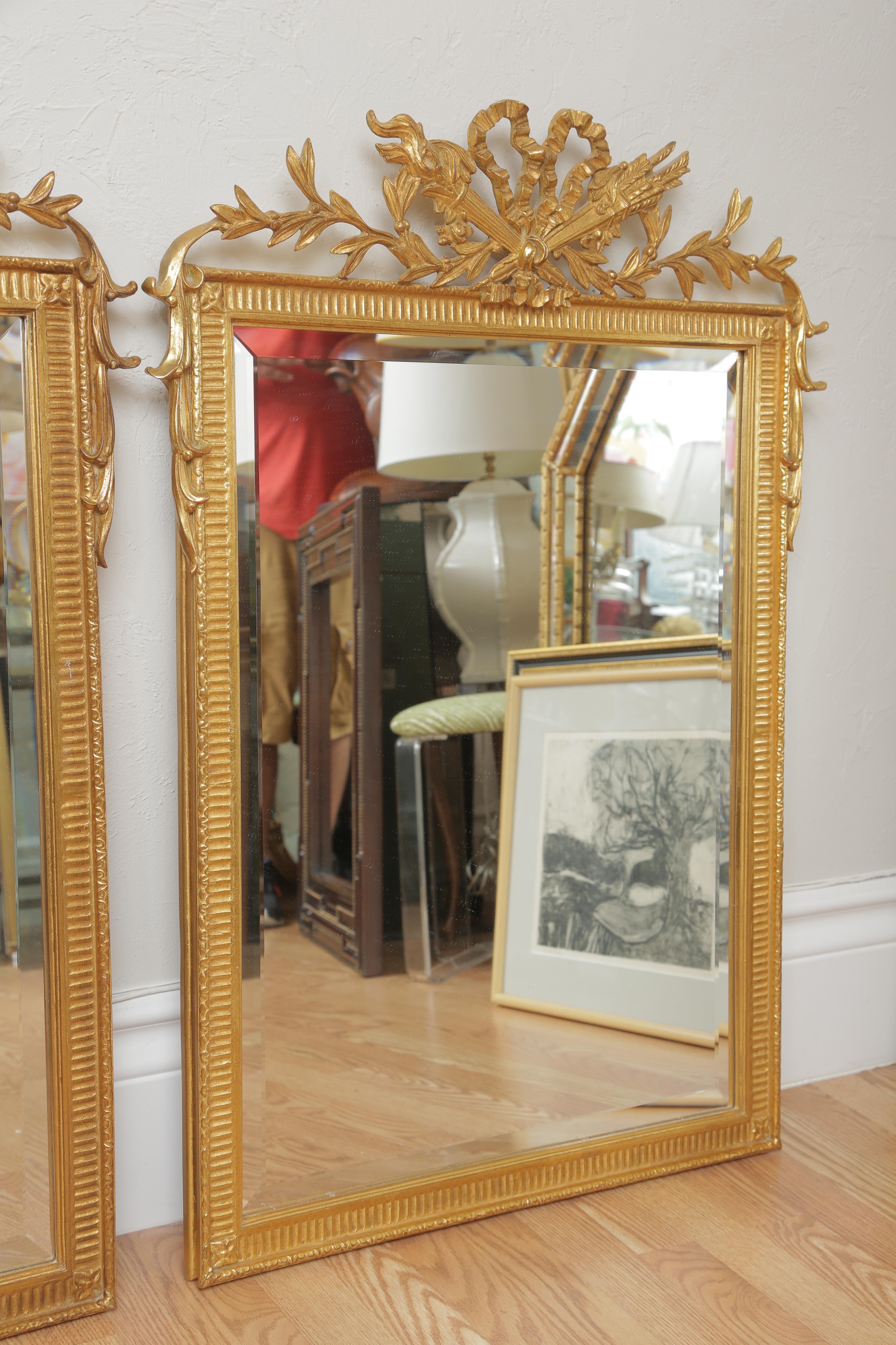 Pair of gilded French hunt mirrors by Carver's Guild.