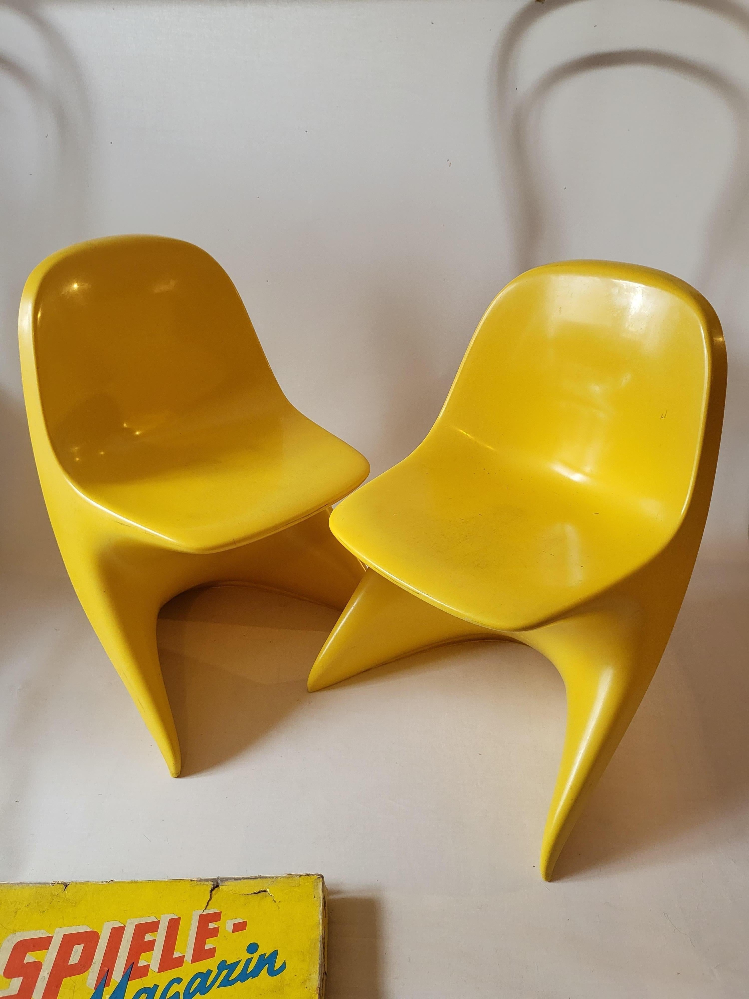 These chairs are made of plastic and are stackable. Both chairs are stamped 