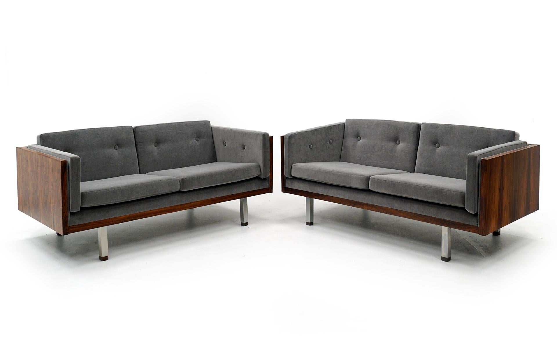 Set of two love seat / settees designed by Jydsk Mobelvaerk, Denmark, 1960. Stunning Brazilian rosewood with new grey velvet upholstery. Chrome legs with rosewood caps. These have both been expertly restored and refinished. As close to perfect as