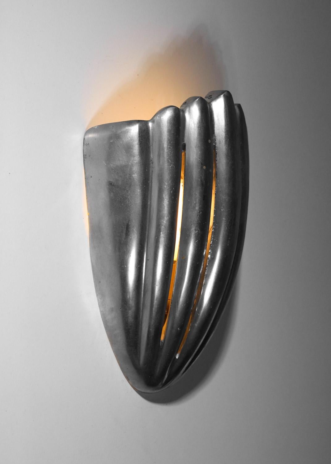 Pair of French wall lights from the 1950s. Shell-shaped structure in aluminum cast.Good vintage condition, signs of age and use throughout the set (see photos). Beautiful patina of age. Independent sockets.