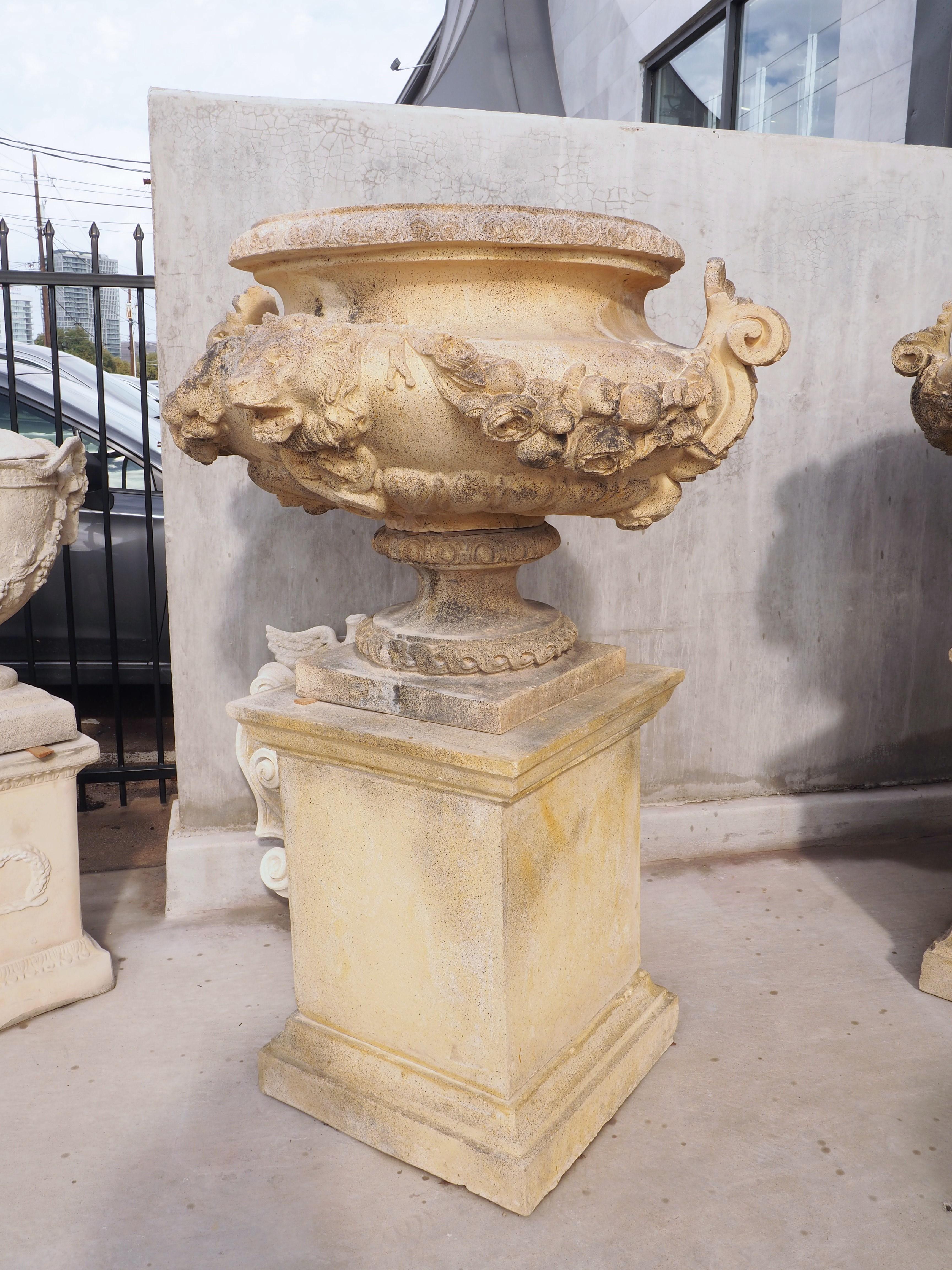 These beautiful French urns on pedestals are re-editions of 19th century French originals by an unknown manufacturer. The color and consistency of the clay used to make these urns also matches the originals. The color is a rich ochre cream with