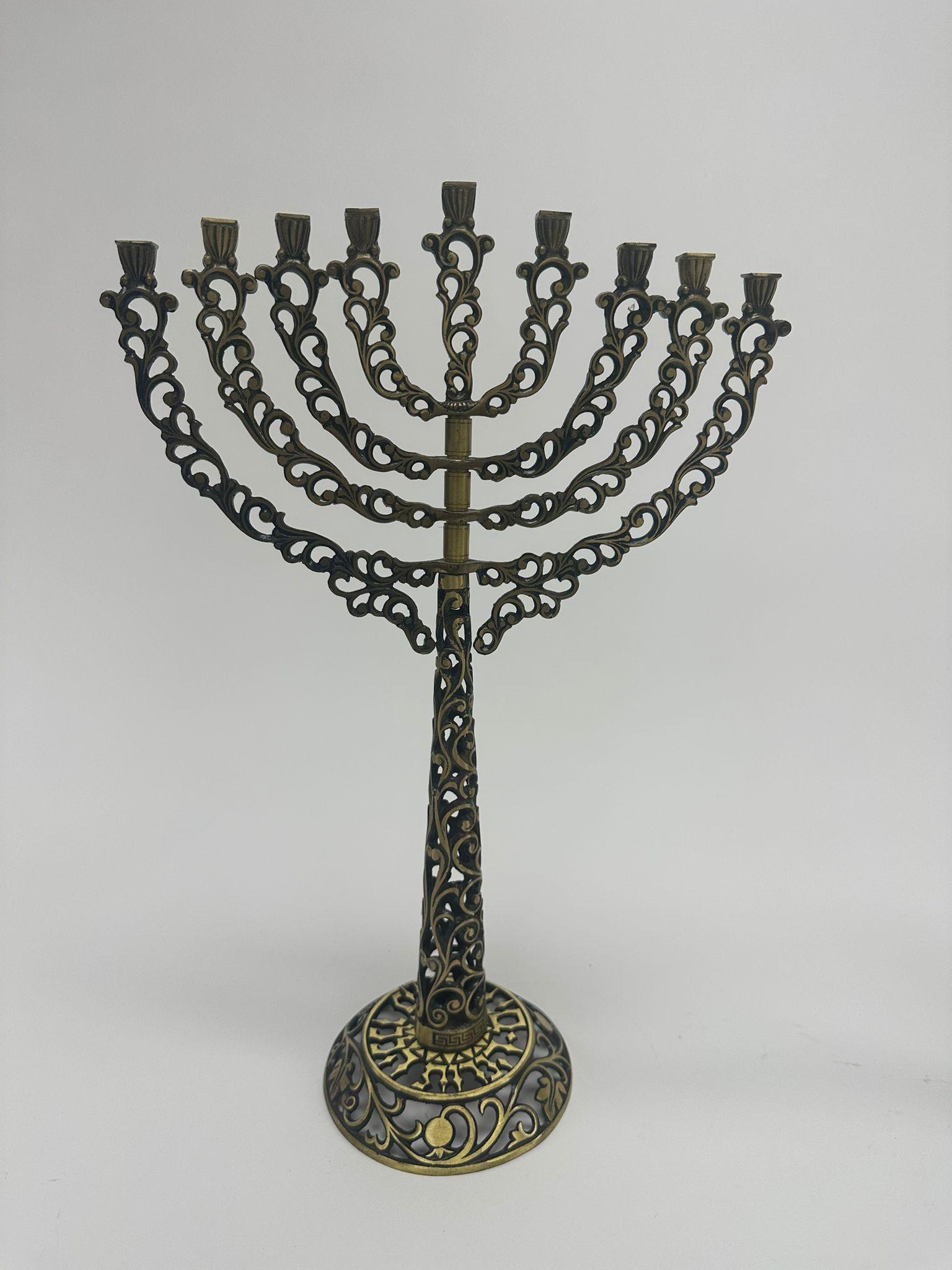 This elegant pair of brass Hanukkah menorahs, produced in 1950 by Oppenheim in Israel, exemplifies the high-quality craftsmanship characteristic of mid-20th-century Judaica. Designed as a matching set for father and son, these menorahs symbolize the