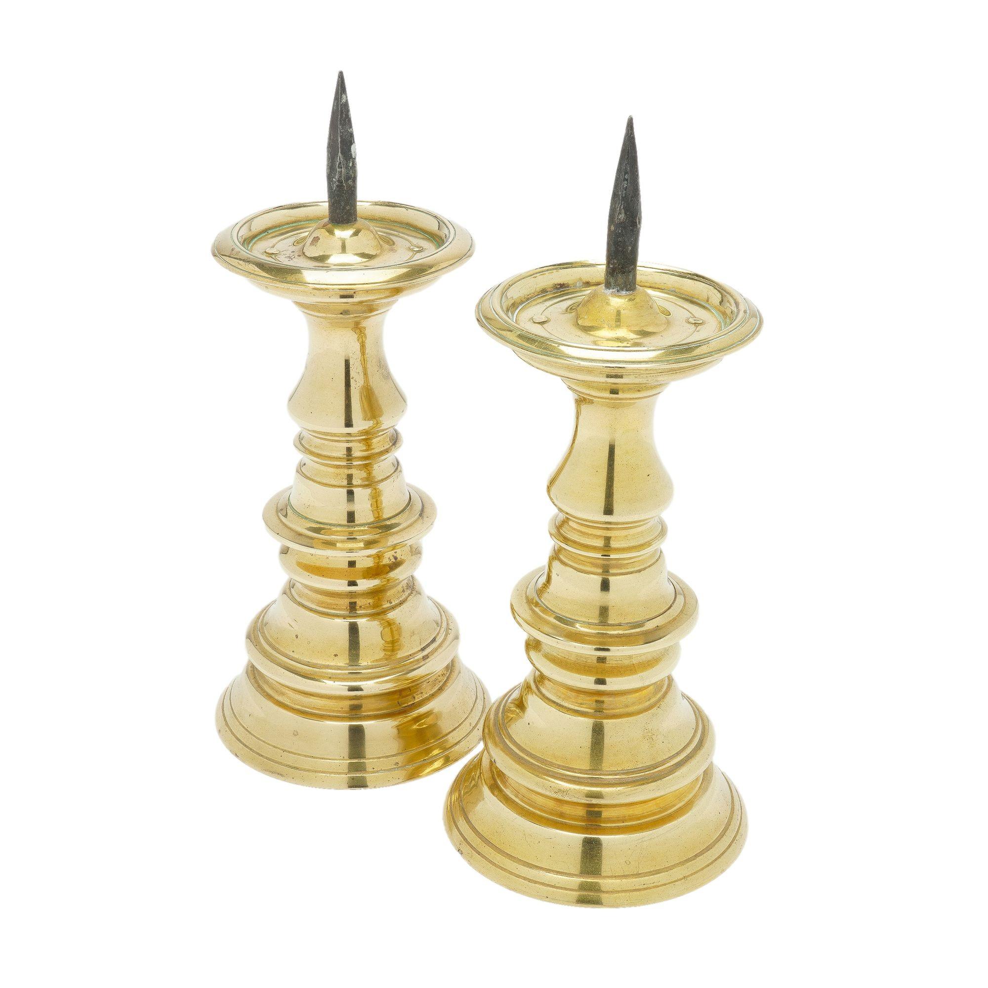Pair of cast brass Jacobean baluster candlestick holders with forged iron prickets.
Stamped with the maker's marks on the underside of the candle cup.
Virginia Metalcrafters for Colonial Williamsburg, circa 1960.