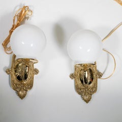 Pair of cast brass sconces with globe shades