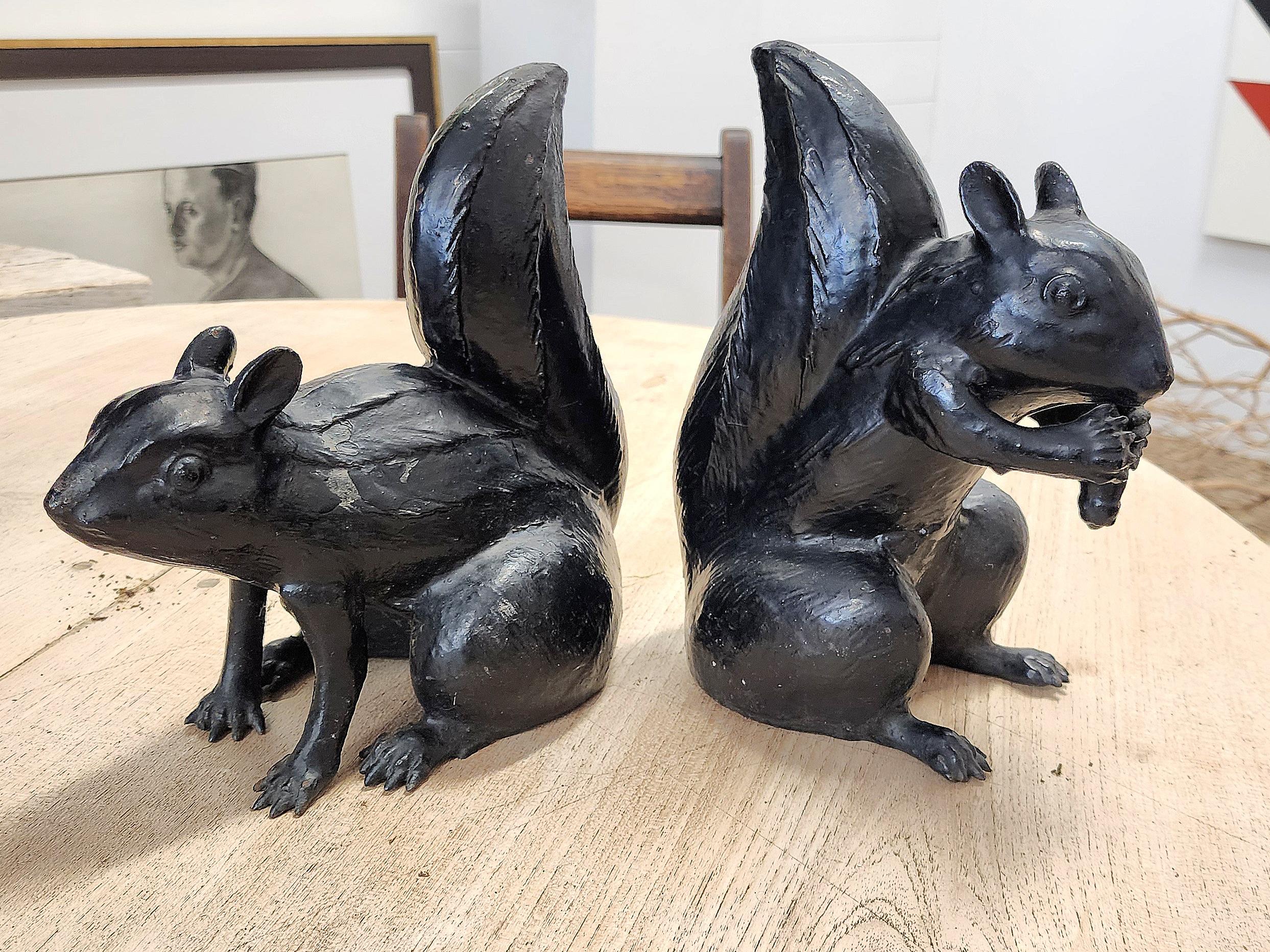 A really handsome and hard to find pair of 1920s cast iron squirrels. Made in and marked Japan, most of these have disappeared over the years. This pair, in its second layer of paint, are charming and very sweet. Perfect for bookends, door stop or