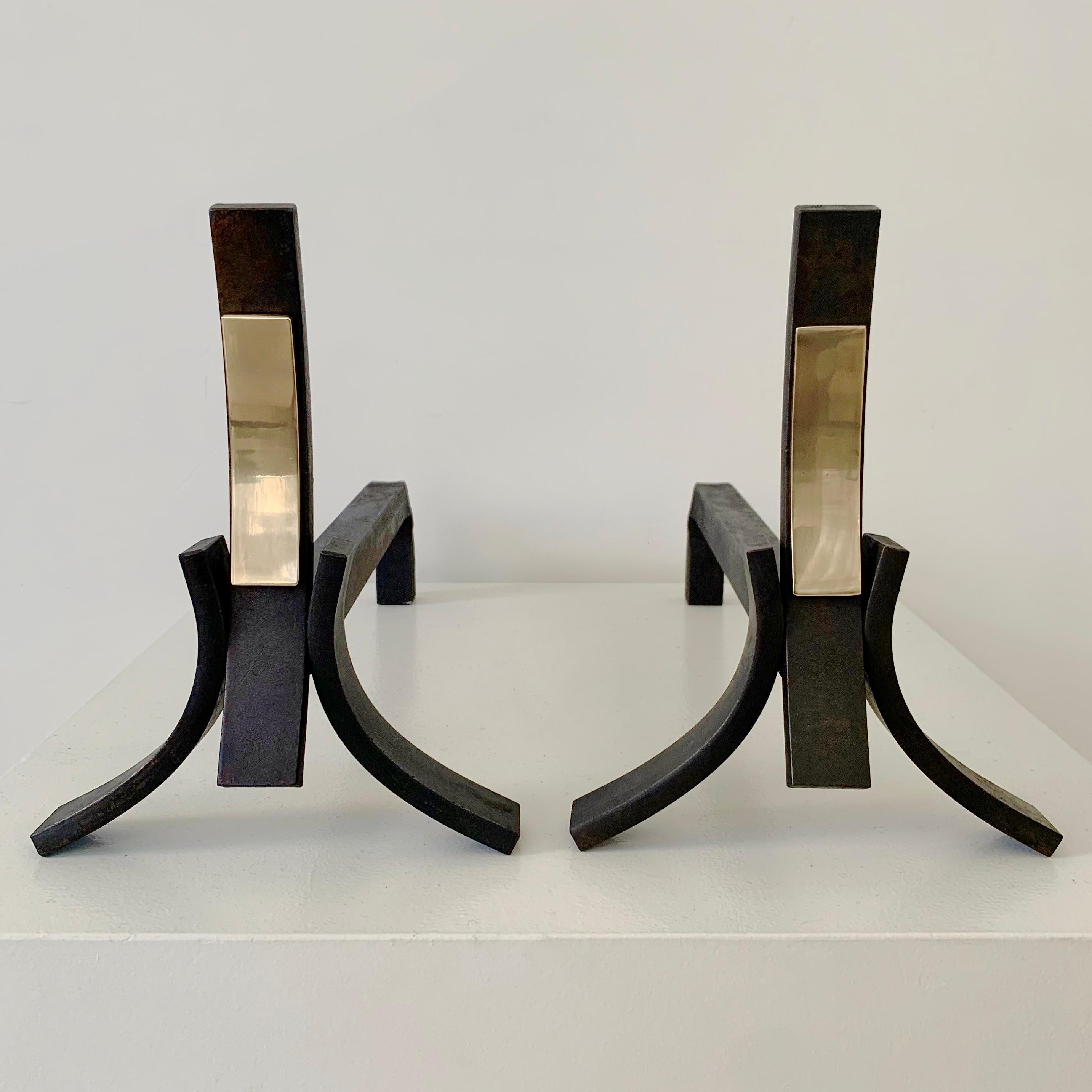 Mid-Century Modern Pair of cast iron and brass andirons, circa 1960, France.