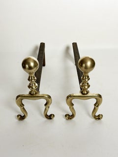 Pair of cast iron and brass andirons, France, 1950
