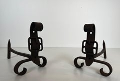 Pair of cast iron and wrought iron andirons representing a belt. French work.