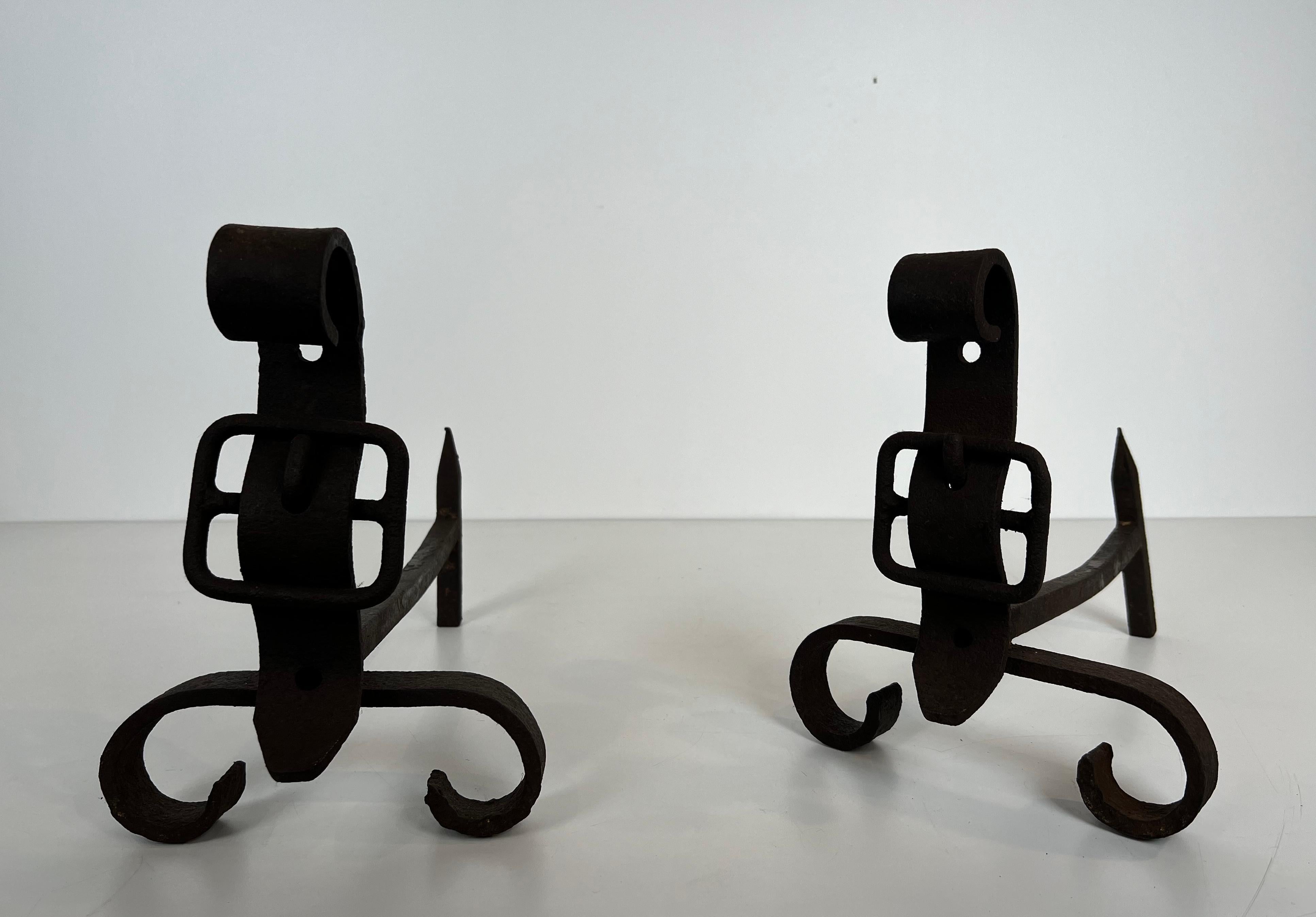 Mid-Century Modern Pair of cast iron and wrought iron andirons representing a belt. French work. For Sale