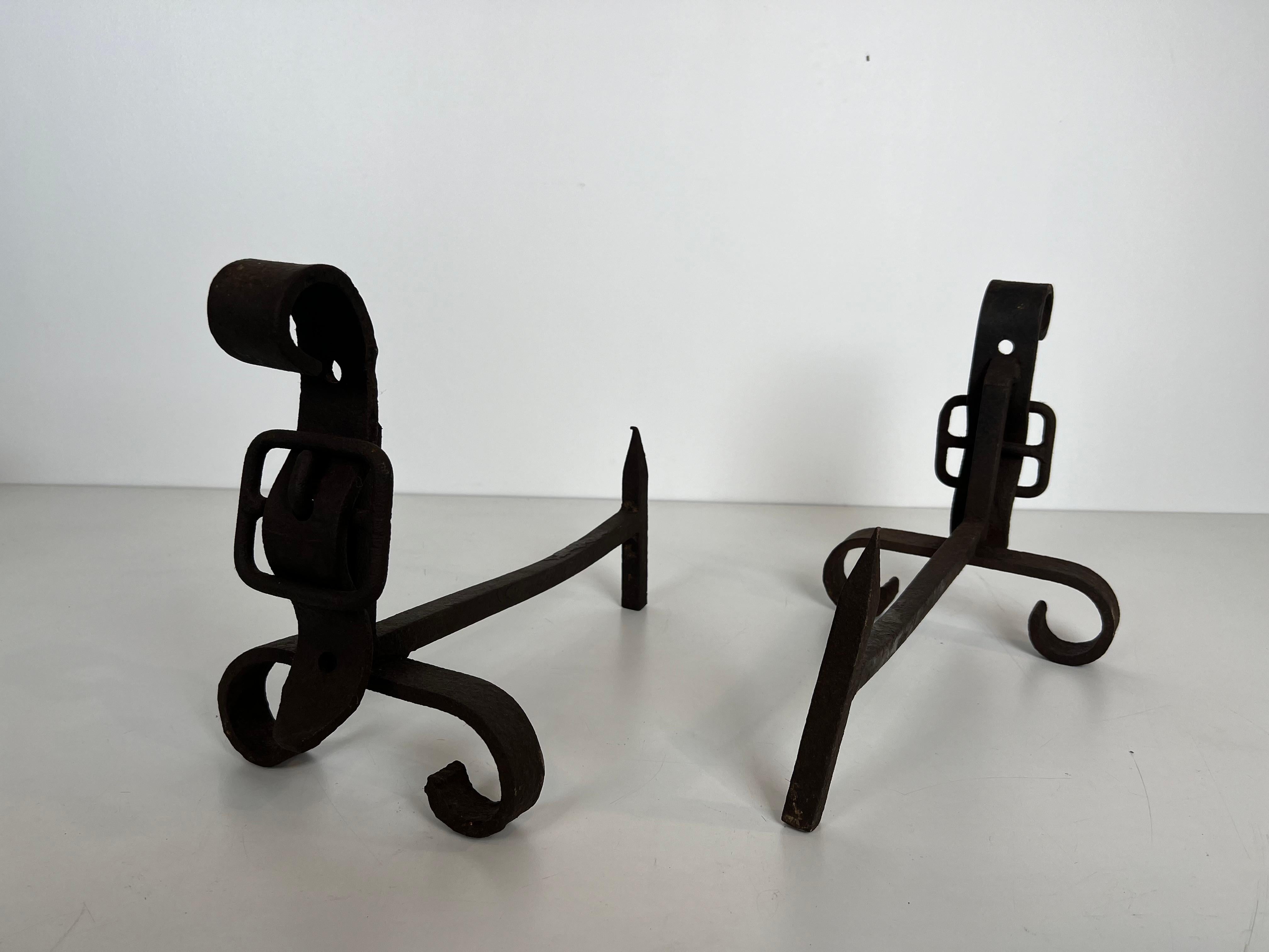 Metal Pair of cast iron and wrought iron andirons representing a belt. French work. For Sale