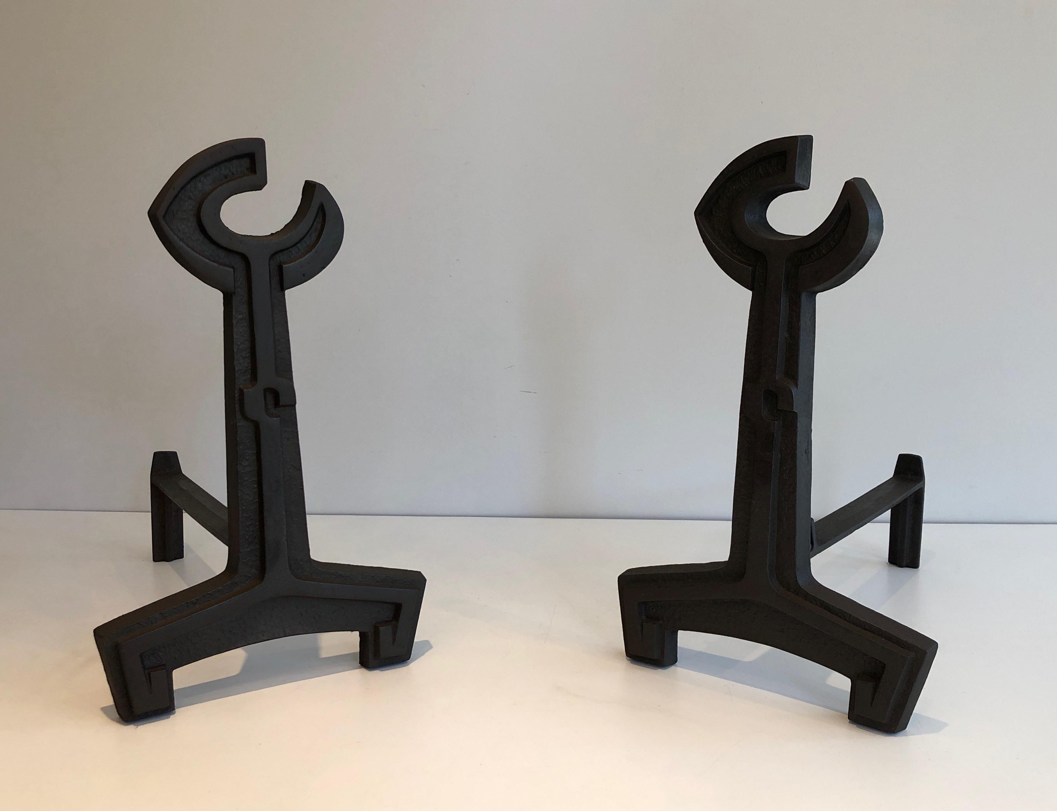 This pair of flat key andirons is made of cast iron and wrought iron. This is a French work, circa 1950.