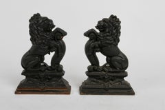 Pair of Cast Iron Andirons or Fire Dogs of Rampant Lions Resting on Shield