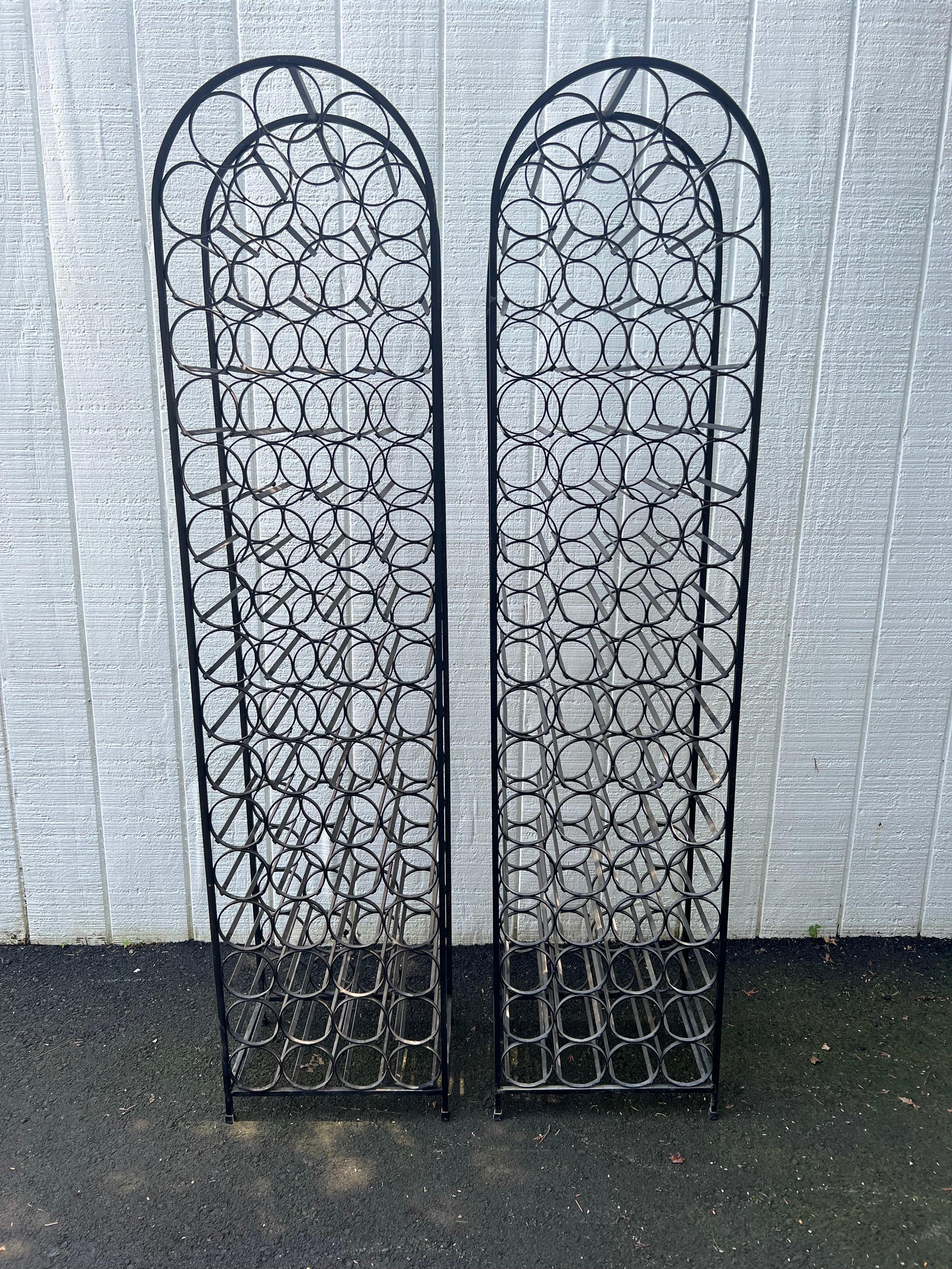 Pair of Cast Iron Arthur Umanoff Wine Racks by Shaver Howard Manufacturing. Classic, timeless design. Sturdy , solid Iron with rubber feet  . These are great space savers and are so attractive they don't need to be stored in a cellar. Each wine rack