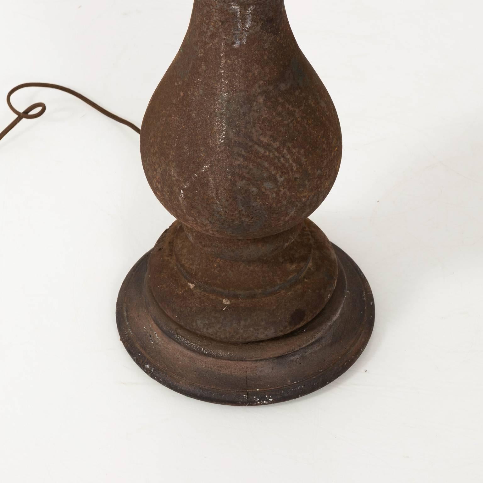 Pair of cast iron baluster lamps with a vase-and-ring turned base and matching finial. Shades not included.
