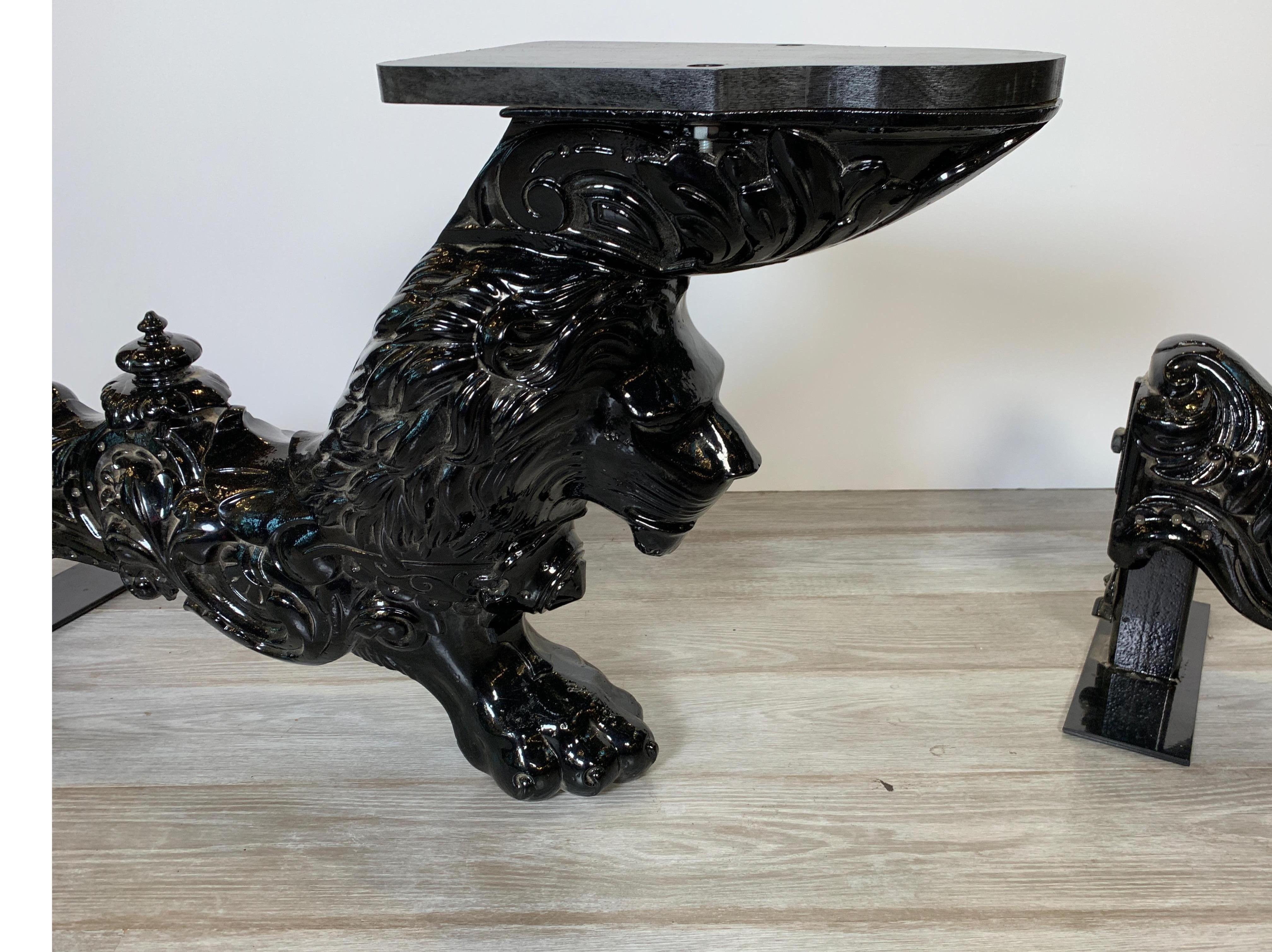 Large cast iron salvaged table legs in the form of lions, repurposed with wooden shelves attached - very unique pieces which could be used in any number of ways, quite remarkable!