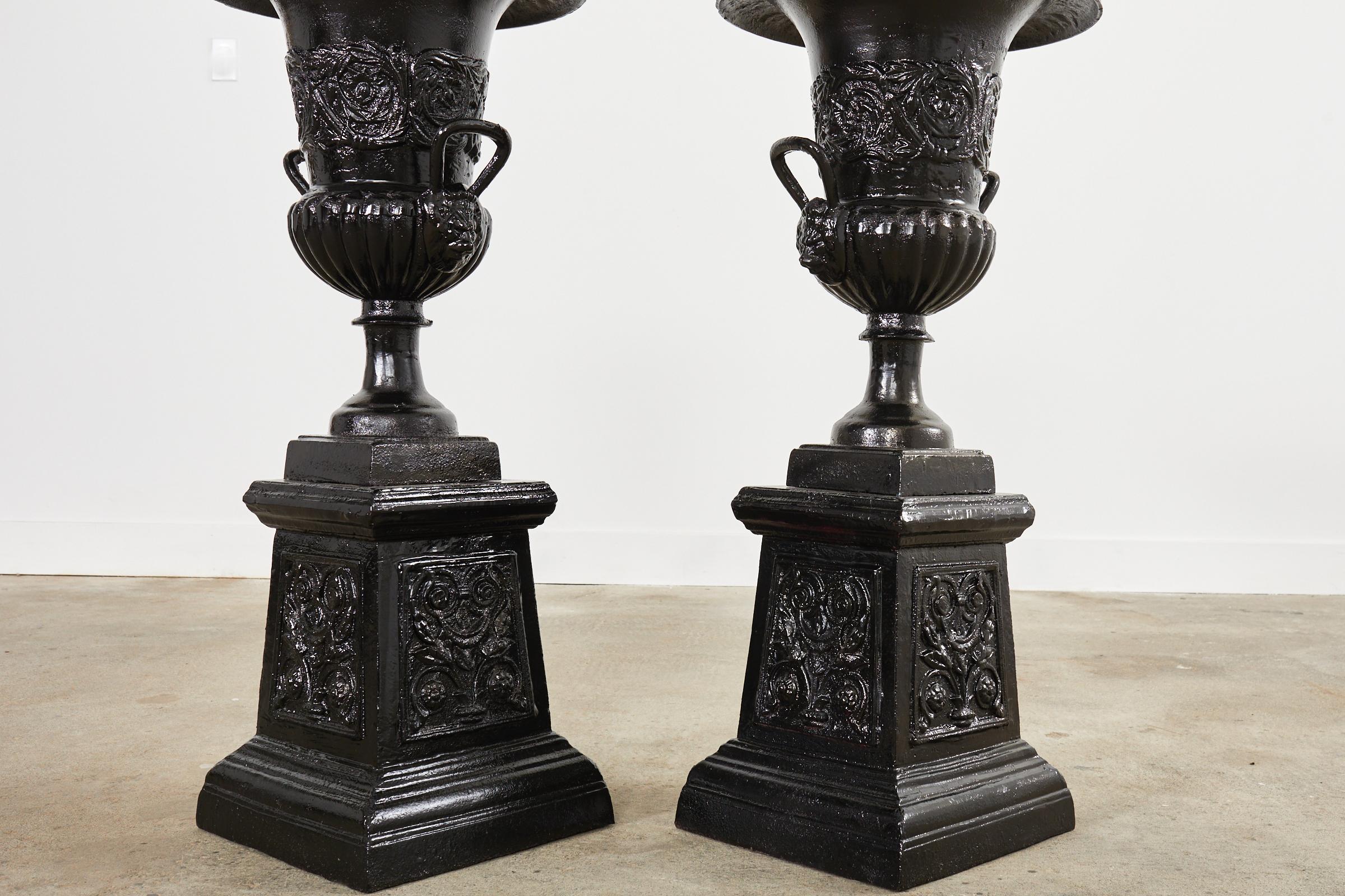 English Pair of Cast Iron Campana Form Garden Urns on Stands For Sale