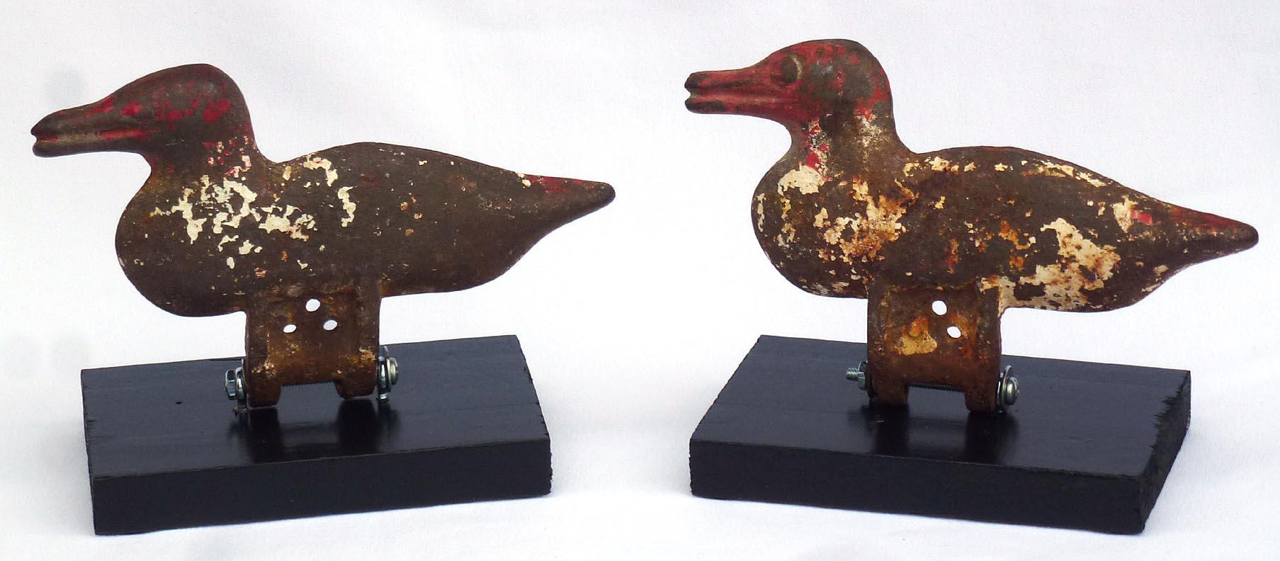 20th Century Pair of Cast Iron Duck Shooting Gallery Targets with Worn Red and White Paint