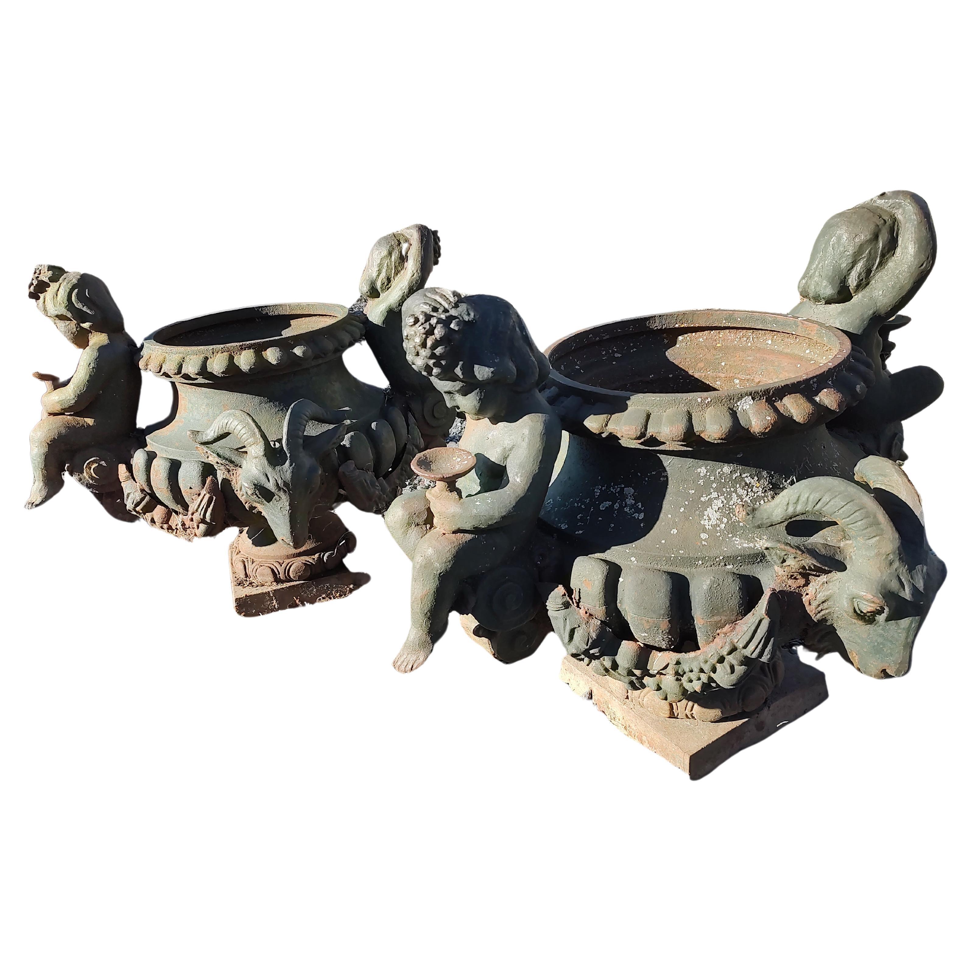 Pair of Cast Iron Figural Garden Urns with Cherubs & Rams Heads For Sale