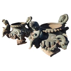 Pair of Cast Iron Figural Garden Urns with Cherubs & Rams Heads