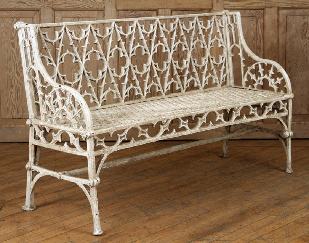 A pair of cast iron Gothic style garden benches in the manner of Coalbrookdale, 20th century.