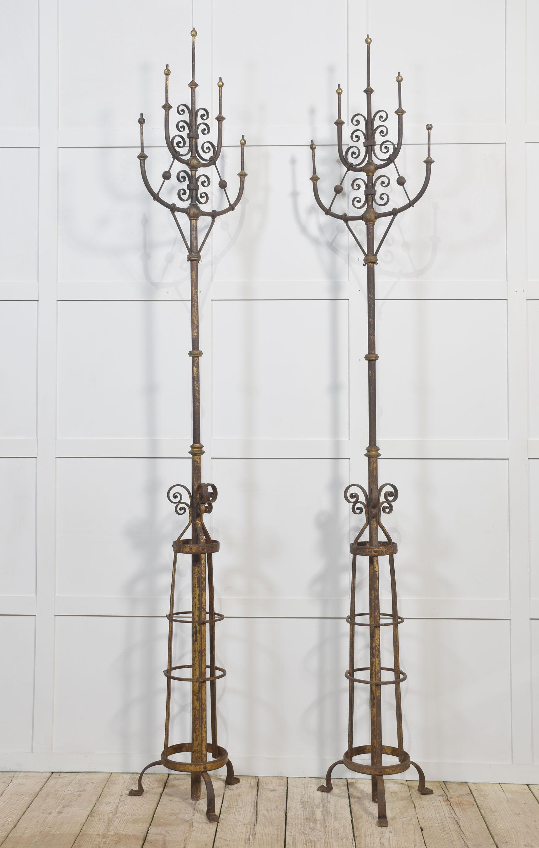 Pair of Monumental gilded cast iron glass light candelabras, each with five arms having scrolling decoration, raised up on circular stems with ring decoration terminating in shaped feet. (The candelabras can be gas powered however, they have not