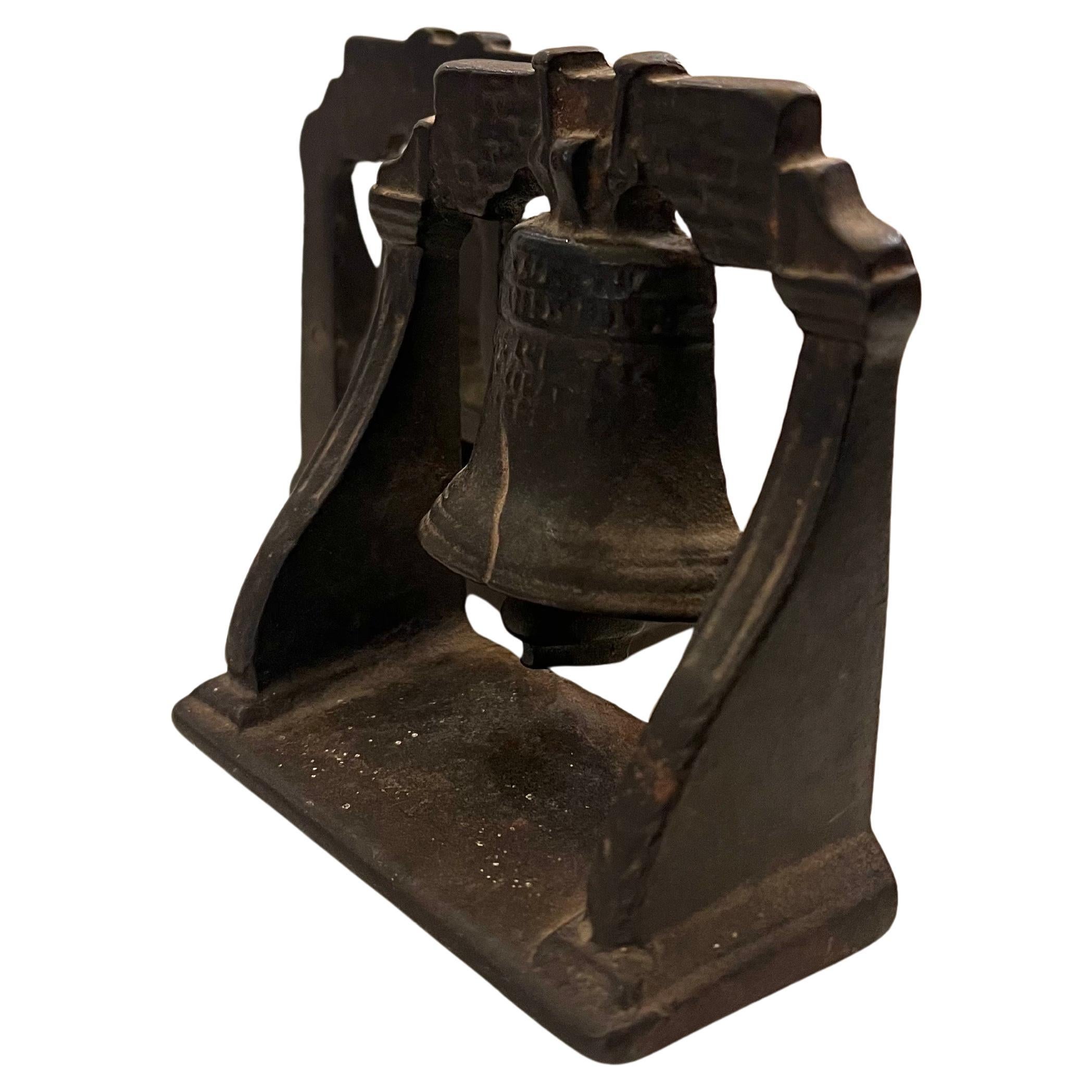 Great and rare pair of patinated cast iron liberty bell bookends nice original condition.