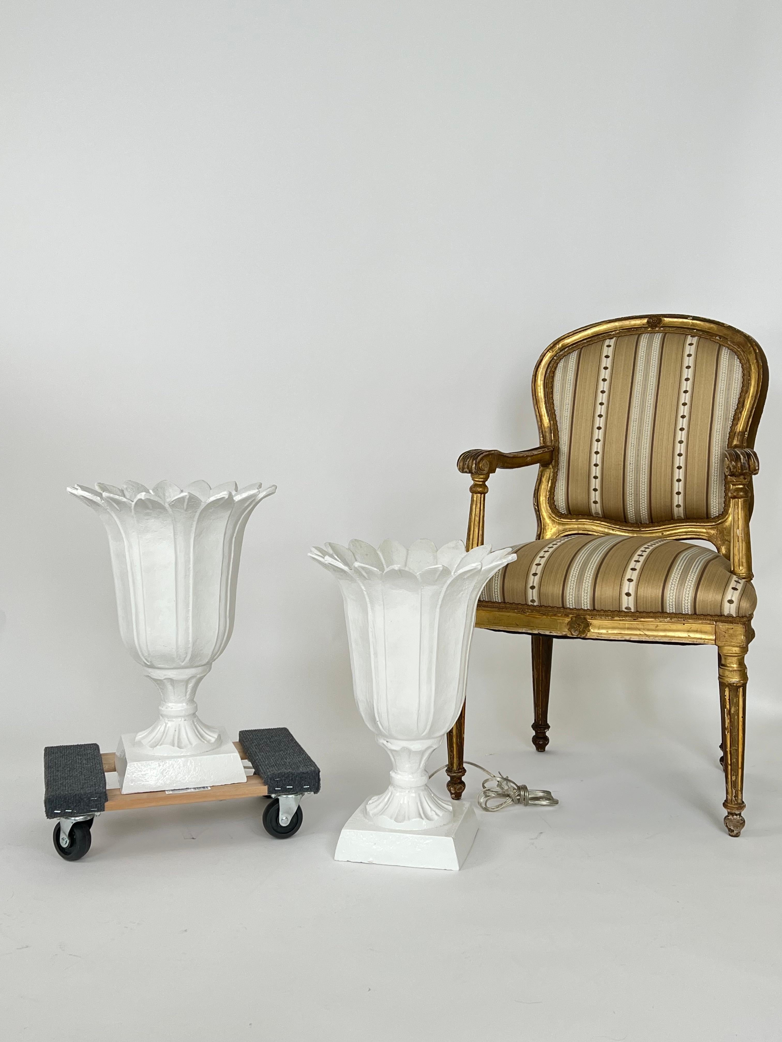 Fabulous and Unique, set of two vintage urn torchiere lamps made from a heavy cast iron and painted white. Very good vintage condition with no rust or major imperfections. Tested and working.  Wonderful Accent Lamps for your Hollywood Regency