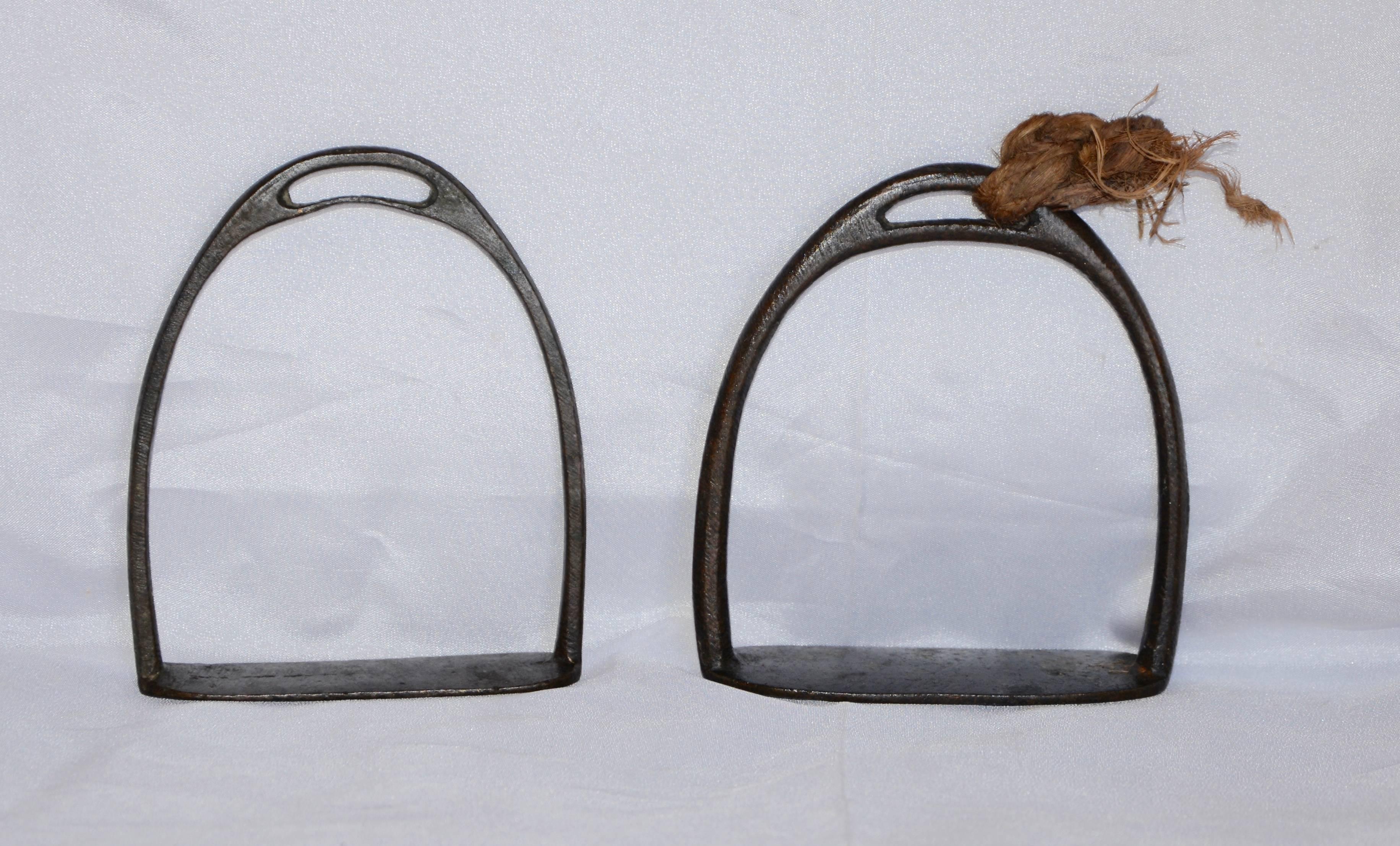 If you love equestriana, you need to add these two handwrought cast iron horse stirrups to your collection! They can serve as bookends, napkin holders, or whatever your imagination conjures up! One still has a piece of an old rope attached. There is