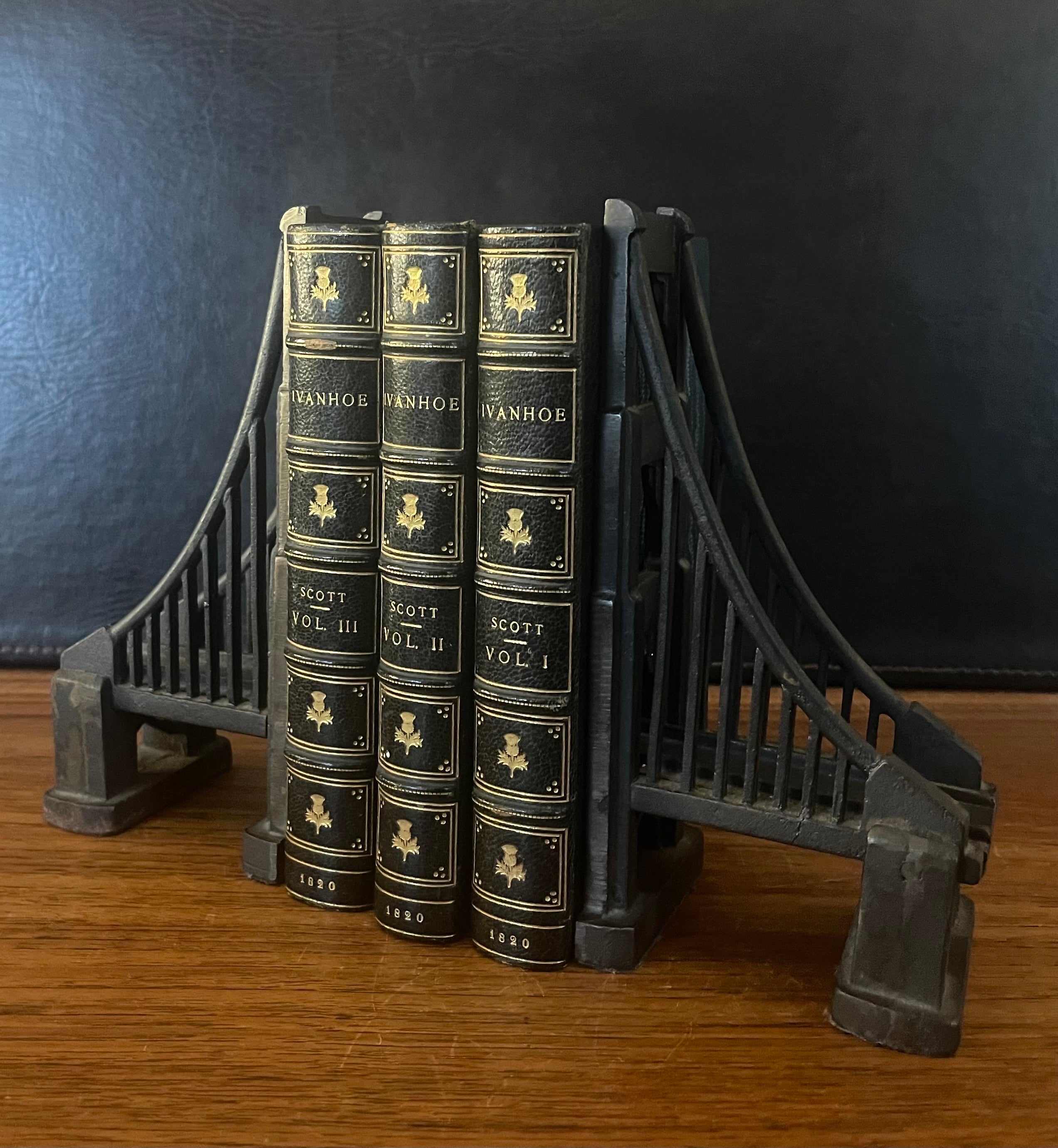 Attractive pair of cast iron supension bridge bookends, circa 2000s. They are quite heavy, in original condition with a nice patina and measure 8.25