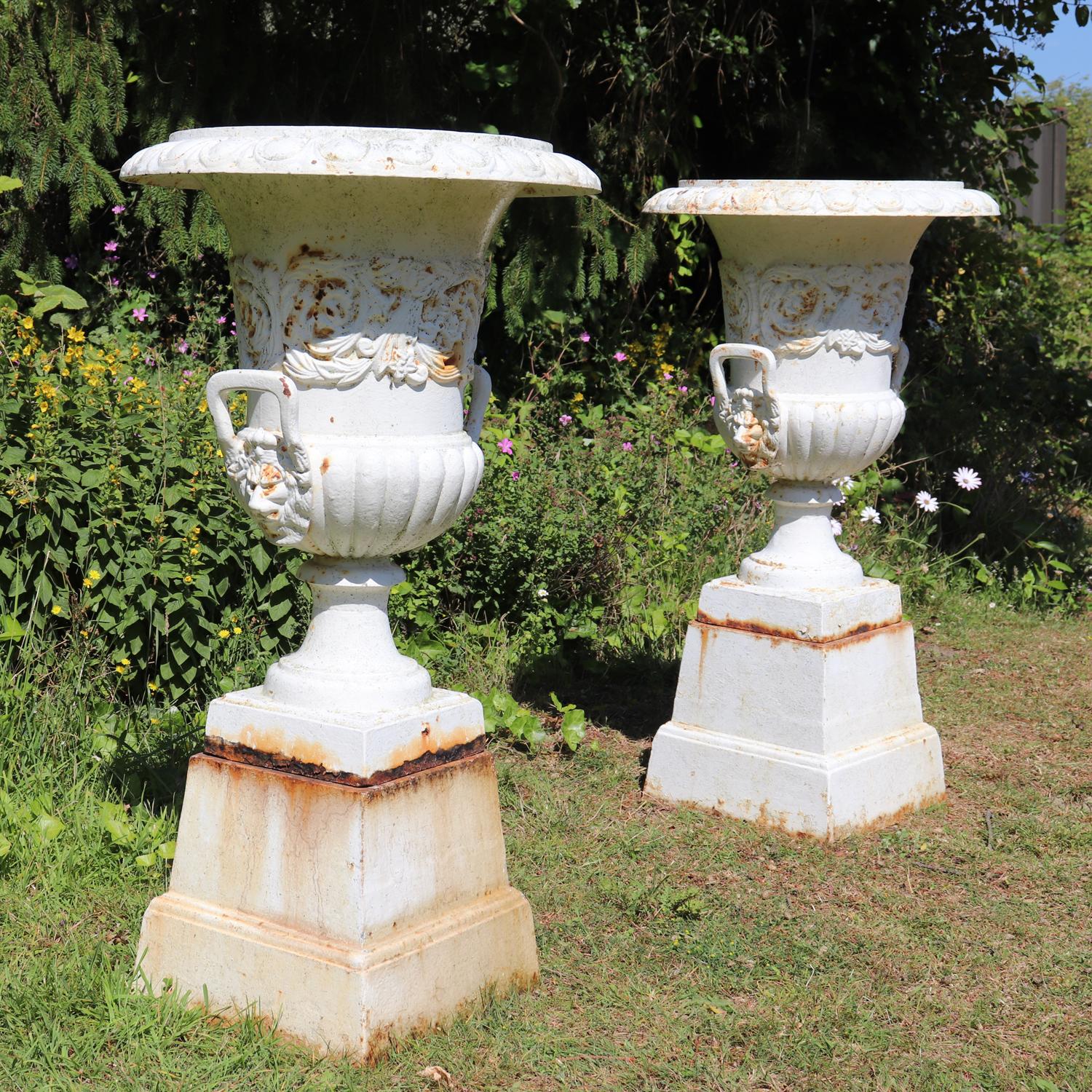 Pair of cast iron urns on plinth
This pair of cast iron urns are a two-piece (Urn on Plinth bases ) With decorative Lion head handles. They are solid cast iron from the 1960s with no damage. They have been weathered and have a slightly rusted