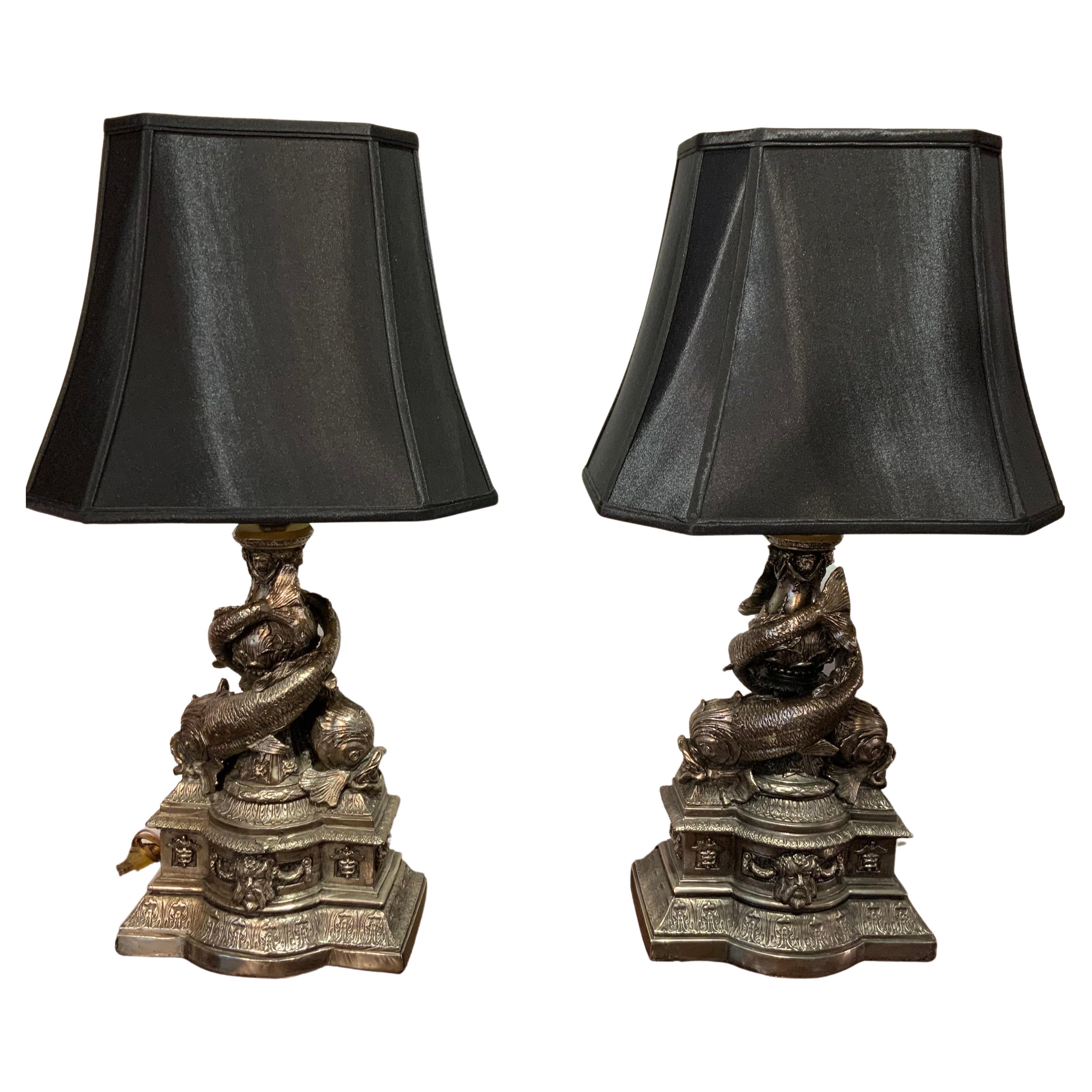 Pair of Cast Metal Lamps with Intertwined Dolphins in a Pewter Hue For Sale