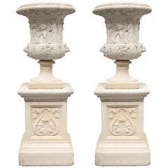 Pair of Cast Neoclassical Urns on Plinths