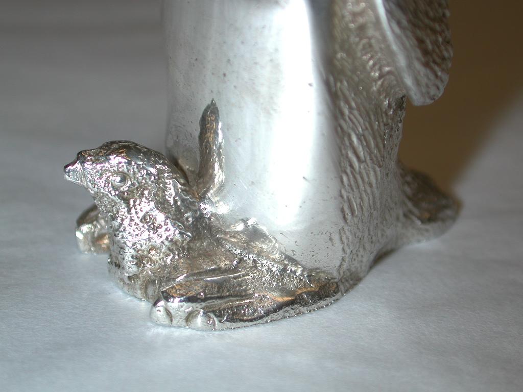 Pair of cast silver penquin pepper and salt shakers,Richard Comyns,London,1992
Each shaker has a baby penquin between their feet.
These were made by one of the finest animal modelers of the day.
They are heavily cast and have a very realistic