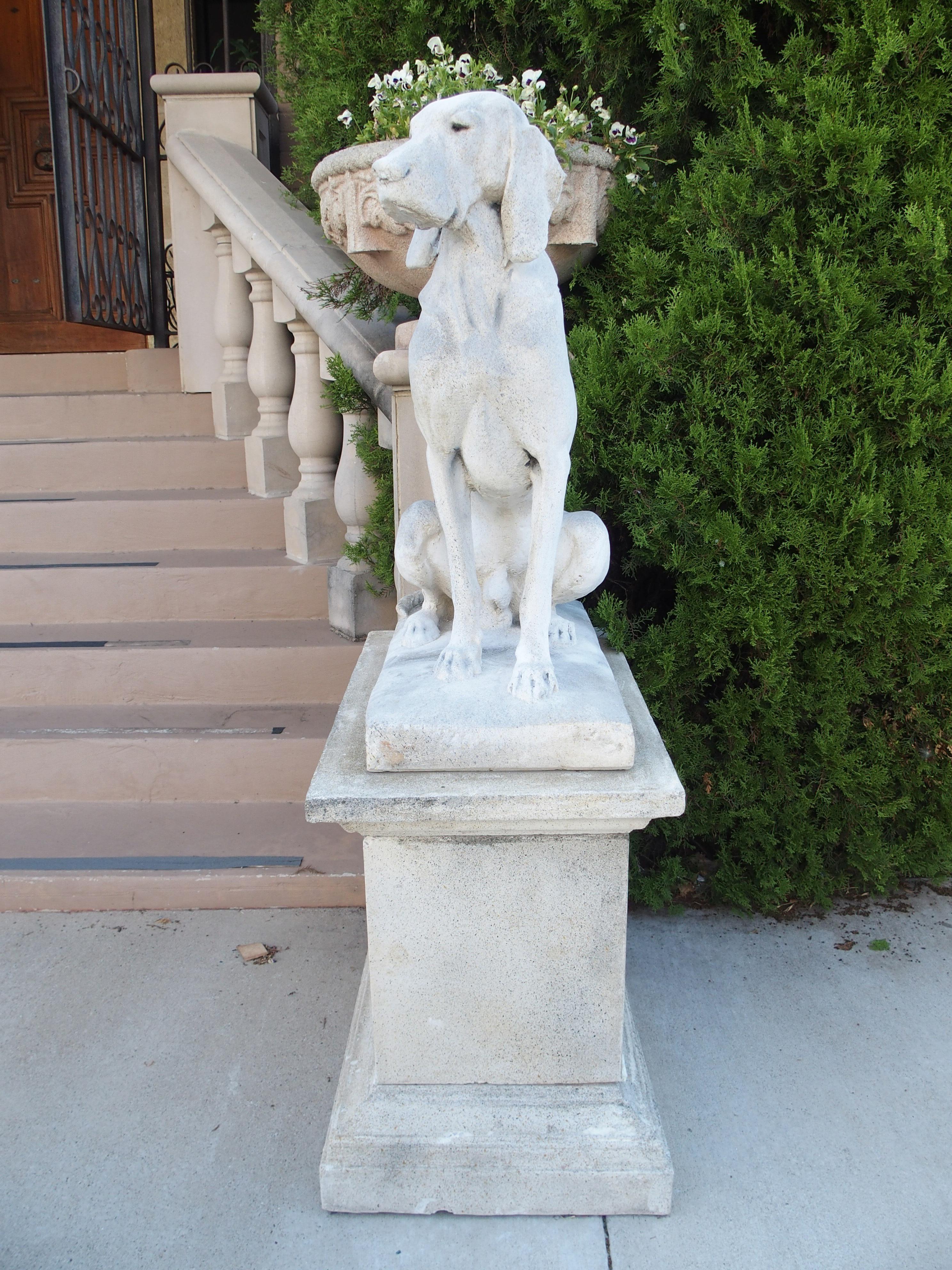 After the original 19th-century hand-carved statues by Alfred Jacquemart, this pair of cast stone European pointers sit atop three-piece rectangular pedestals with several layers of molding. The reconstituted stone has been given a light gray color