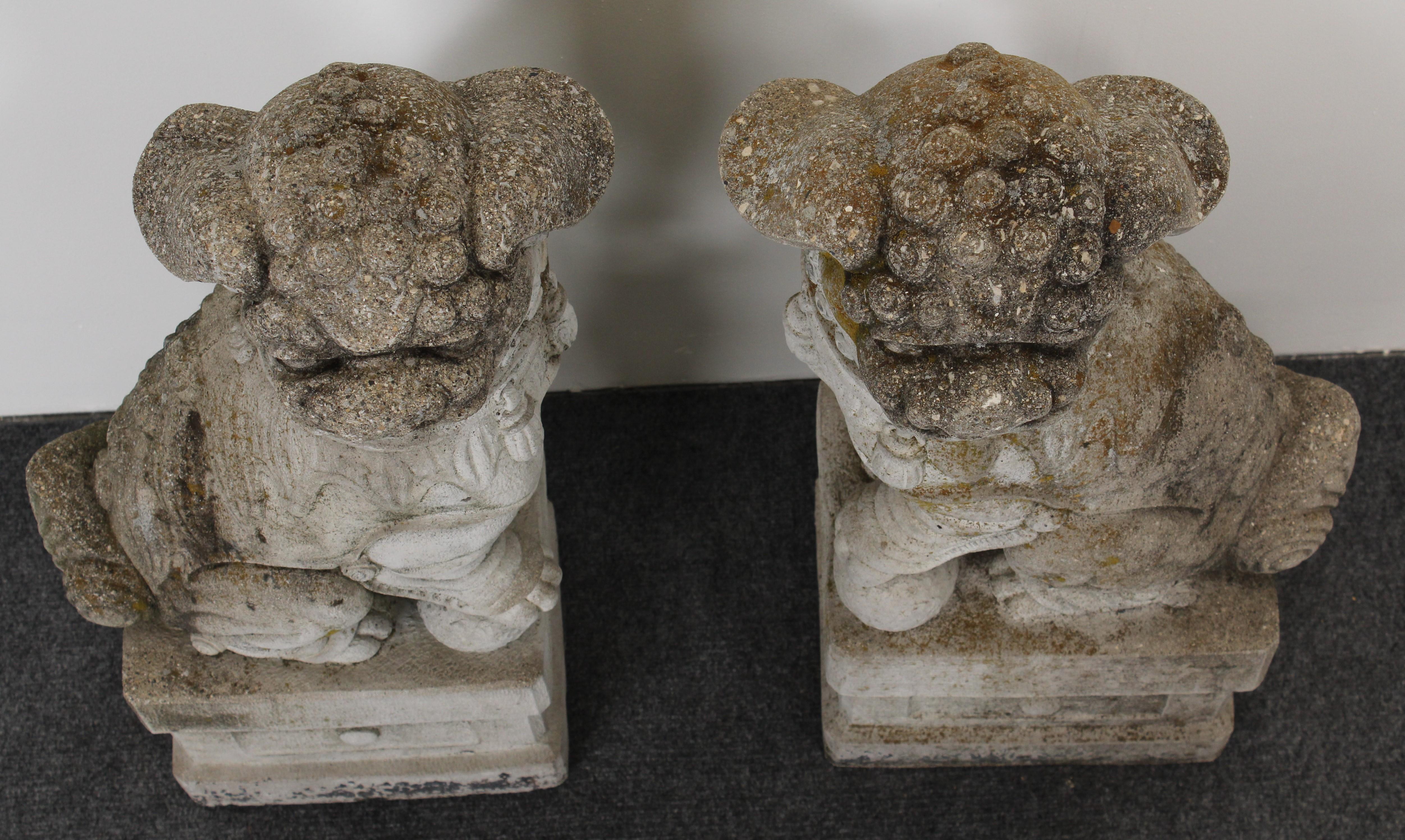 A stately pair of cast stone foo dogs garden statues with a nice patina of lichen and moss.

Dimensions: 31.5