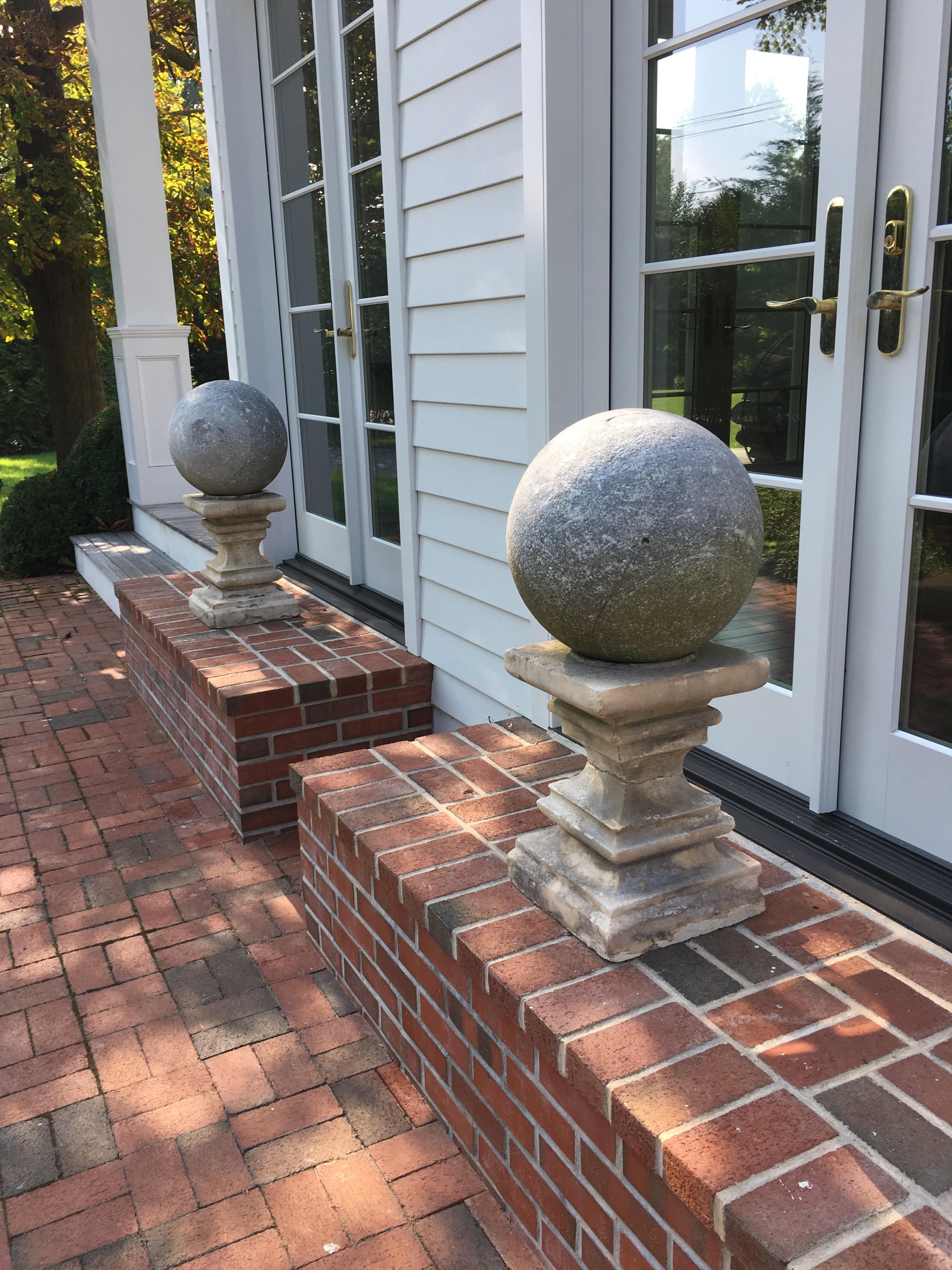 Pair of cast stone garden pedestals with balls. Made of composite stone. One significant crack in one pedestal. These are being sold as a pair. Top and bottom are separate pieces but sold together.

  