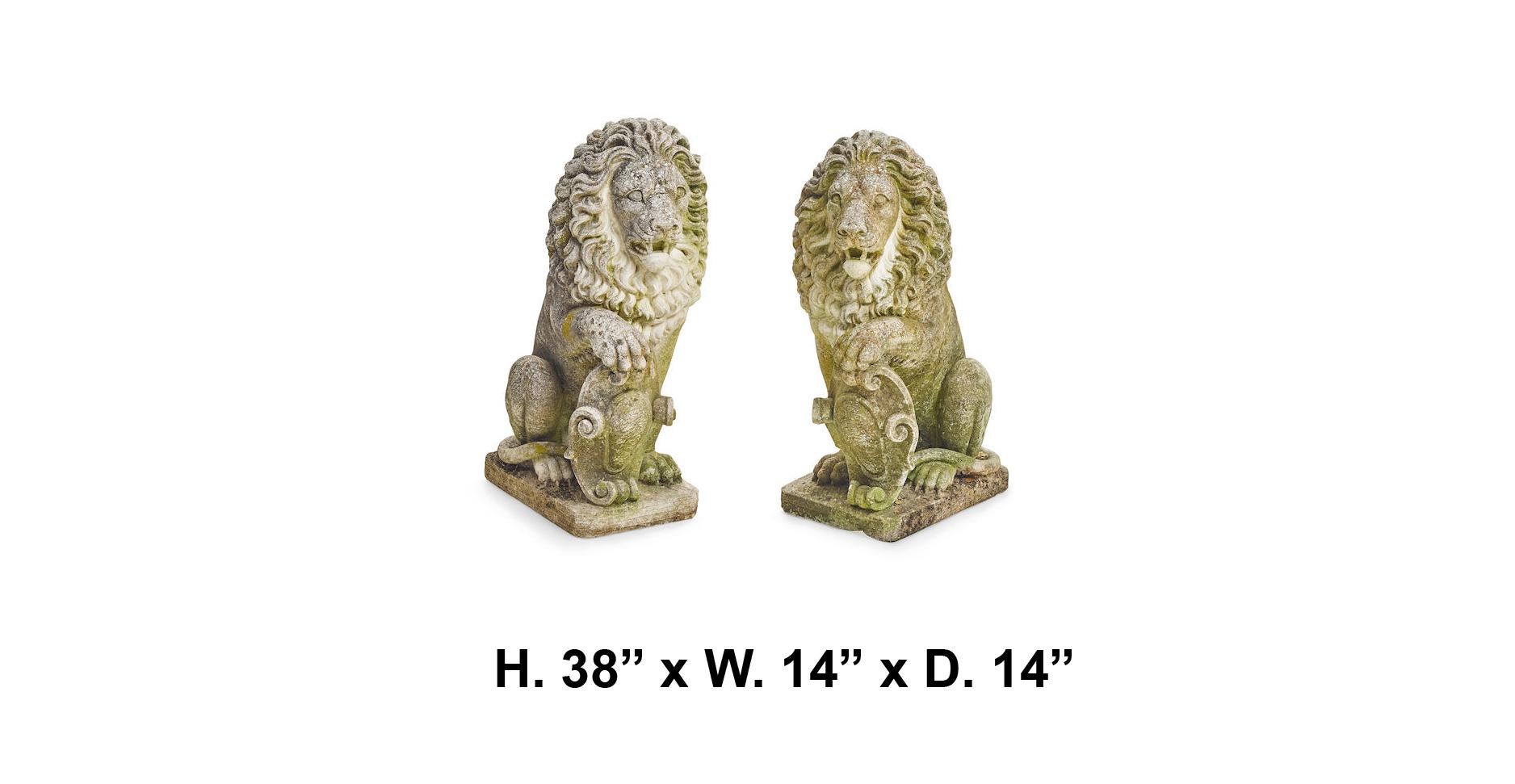 Outstanding and opposing pair of continental cast stone guardian lions with coat of arms, 
mid-20th century.

Each lion is seated on its hind legs with its palm wielding a coat of arms, meticulous attention to the details throughout. The
