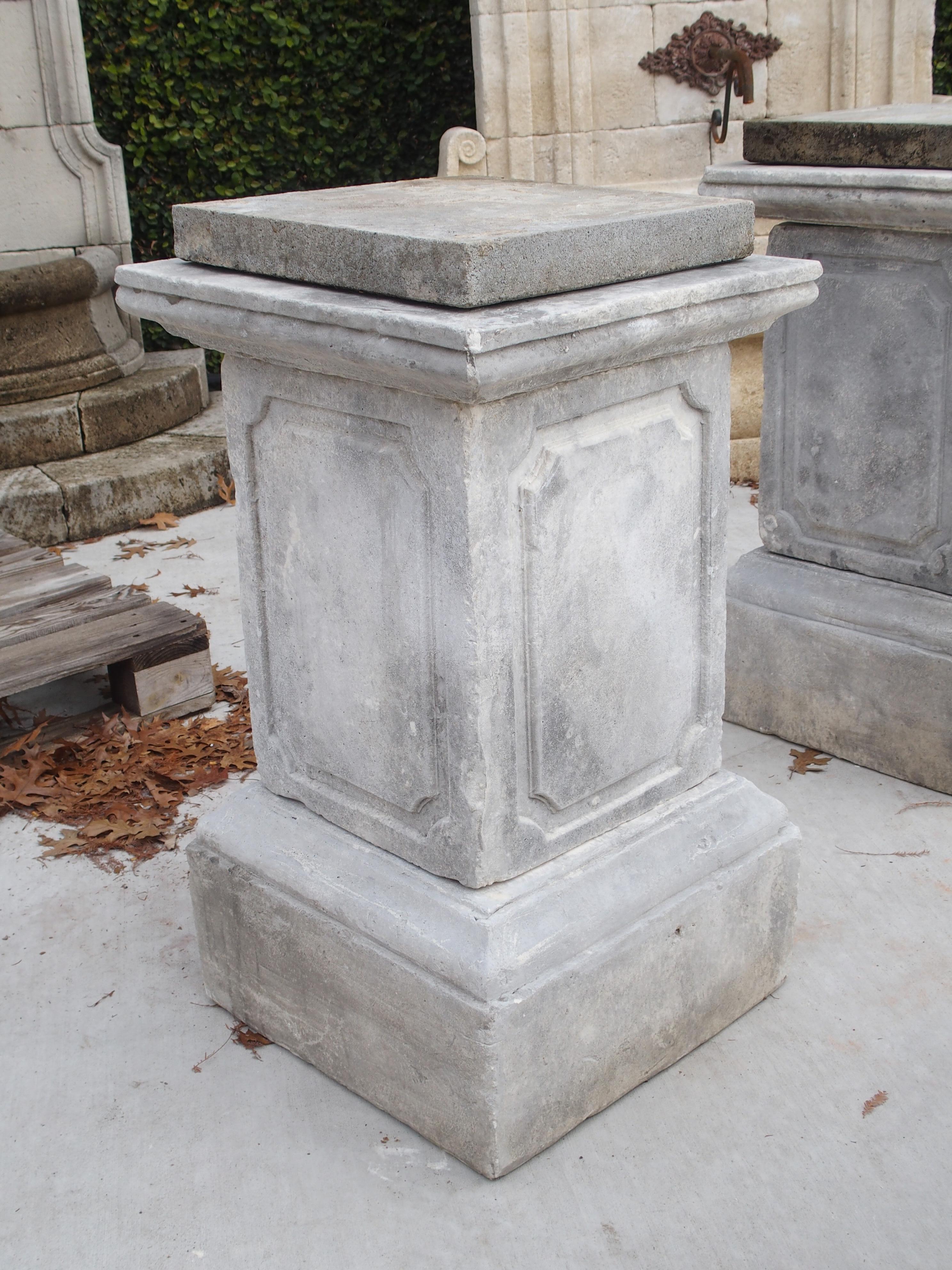 This pair of stone garden pedestals was cast in Southern Italy, and each one is composed of 3 sections. Sometimes referred to as reconstituted or recomposed stone, cast stone in this case, is created by mixing crushed limestone with a proprietary