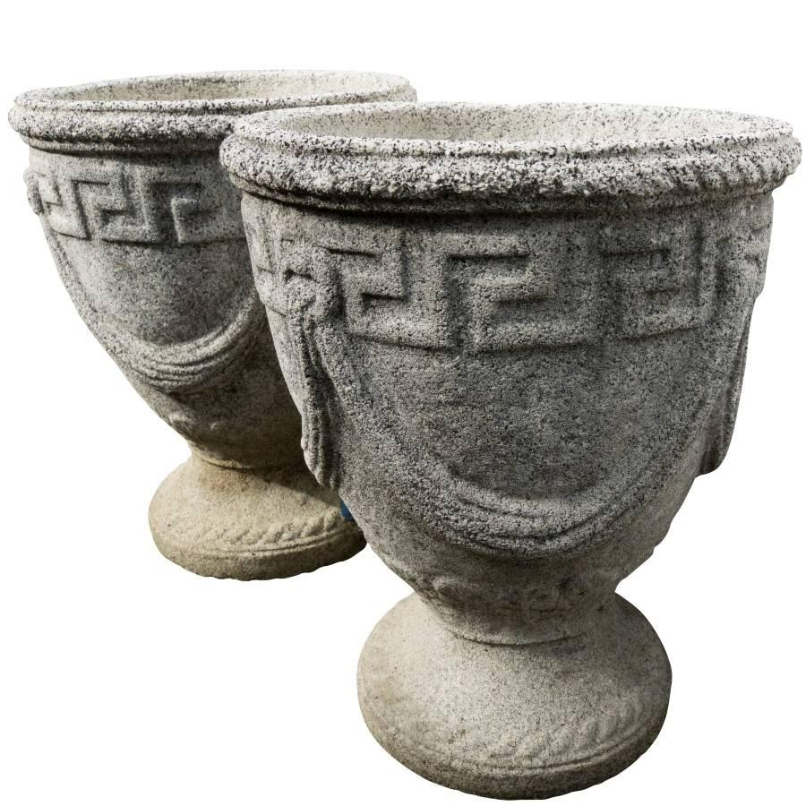 The stone texture, color and embossed Grecian style decoration make this a charming pair of urns. Crafted with symmetry and beauty, fitting for an entrance way or a living room, these urns have a depth in range of stone tones and a handsome