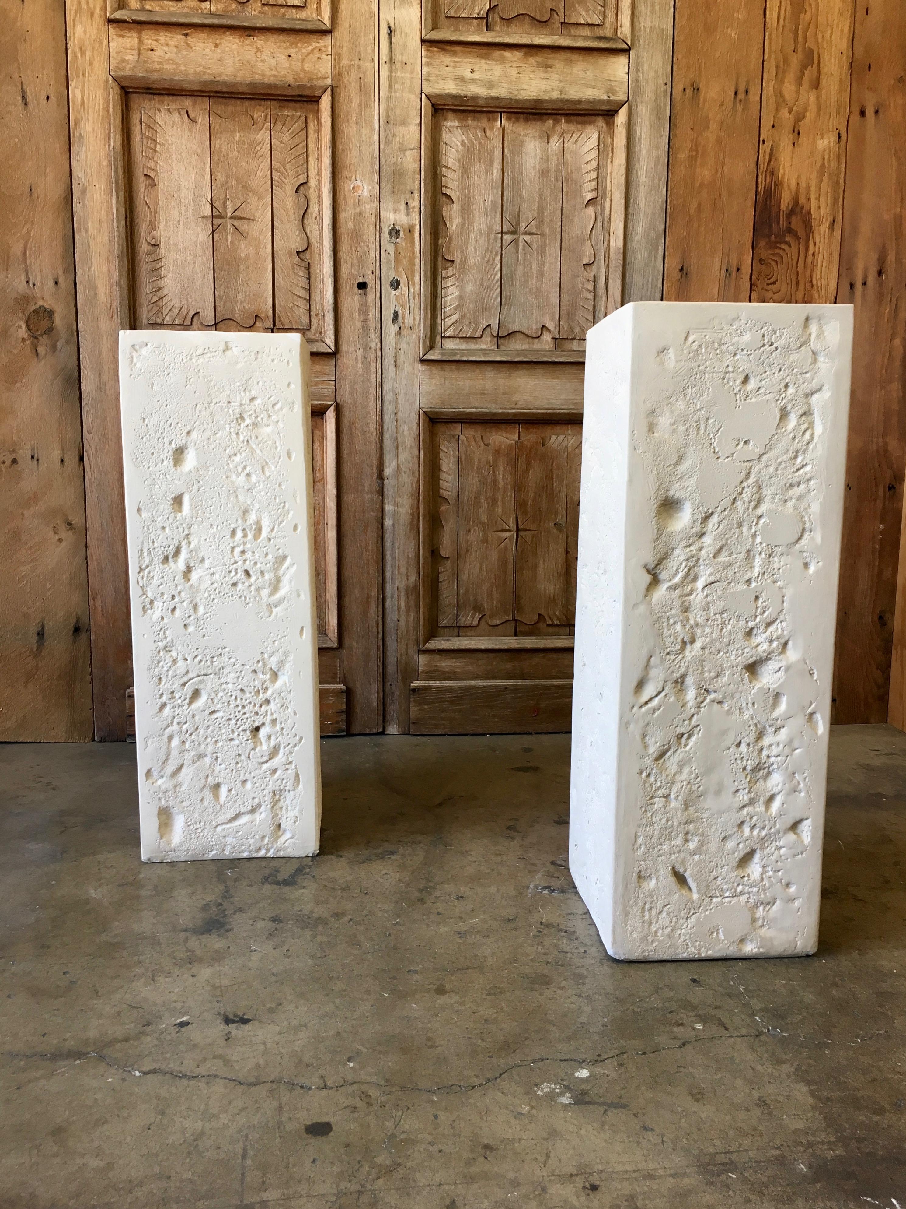 1980s faux travertine / coral columns. They can be used for display of sculptures or add a piece of glass to make a console table.